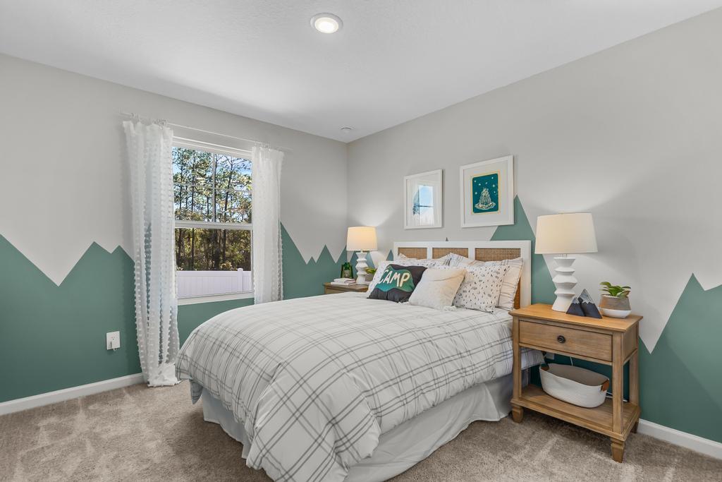 A bedroom with a bed and a table.