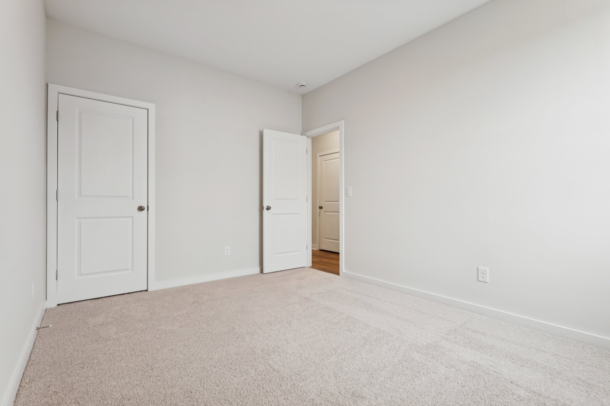 A hallway with white doors.