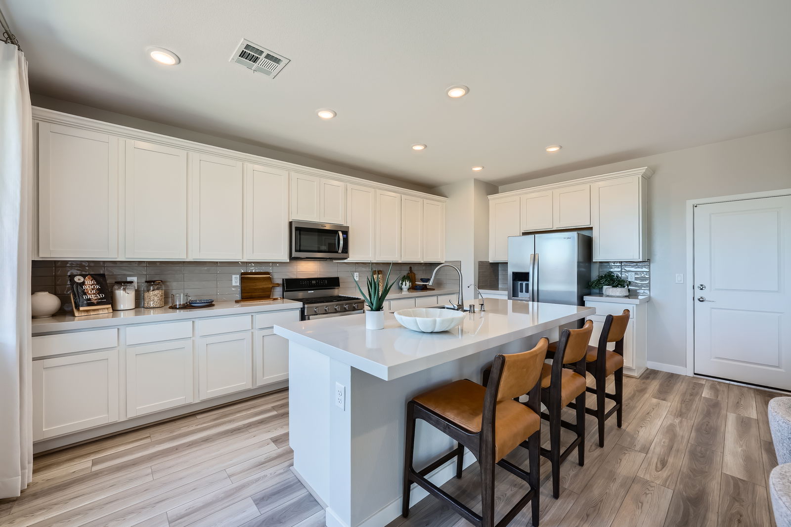 A kitchen with white cabinets.
