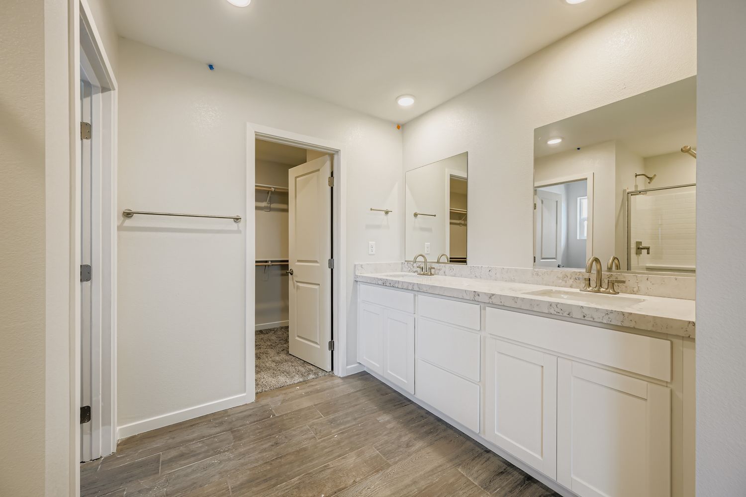 A bathroom with white cabinets.