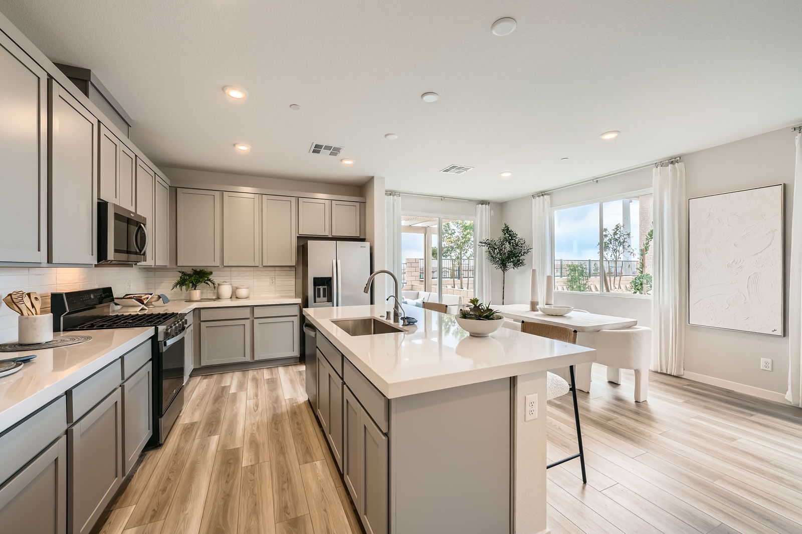 A kitchen with white cabinets.