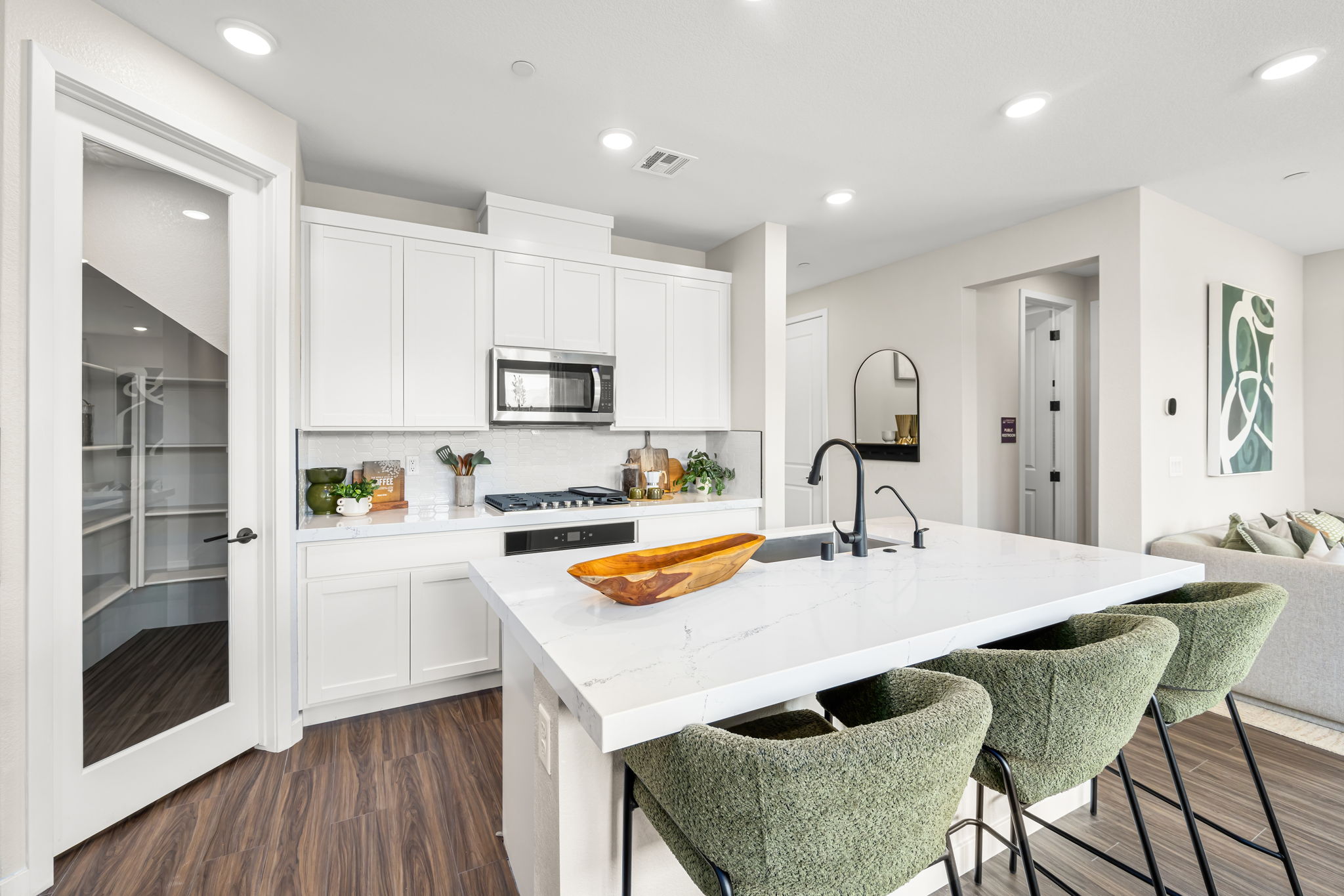 A kitchen with white cabinets.