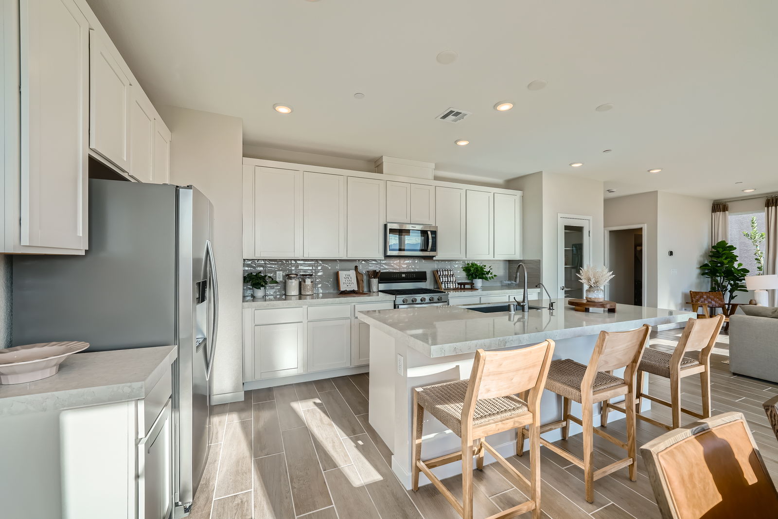 A kitchen with white cabinets.