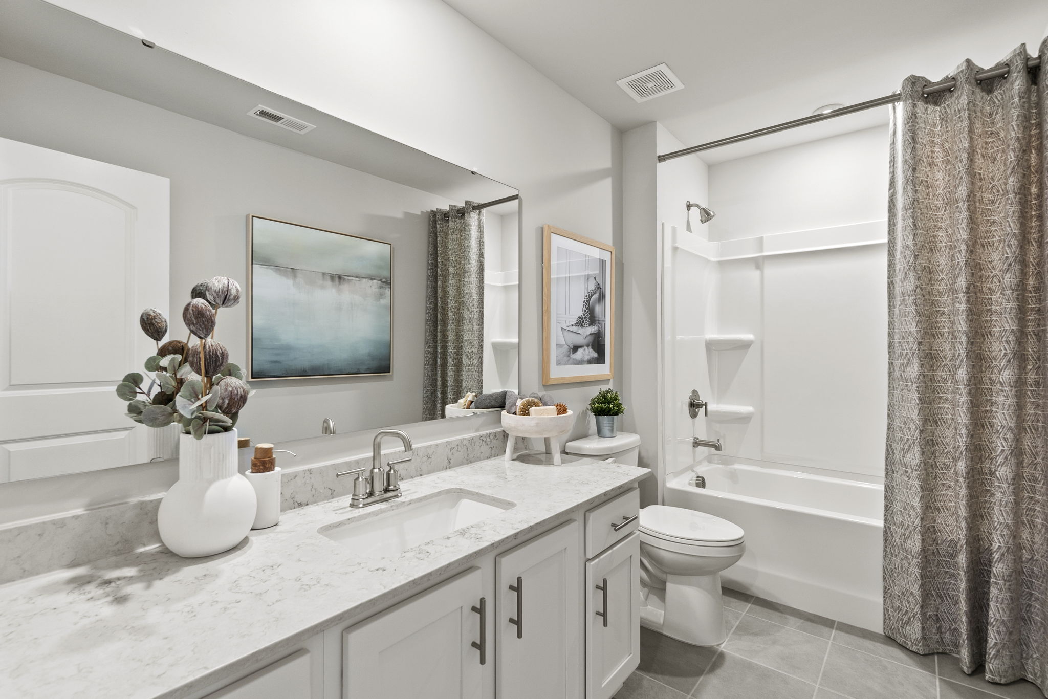 A bathroom with a tub sink and toilet.