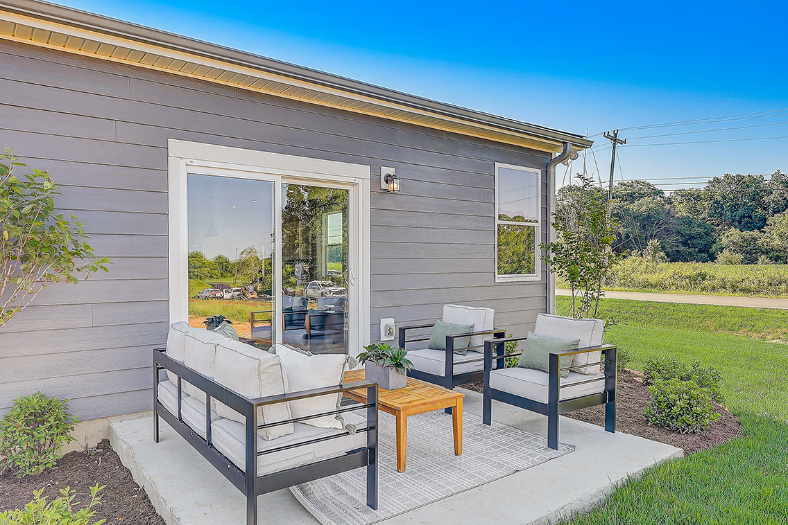A house with a patio and a table and chairs.