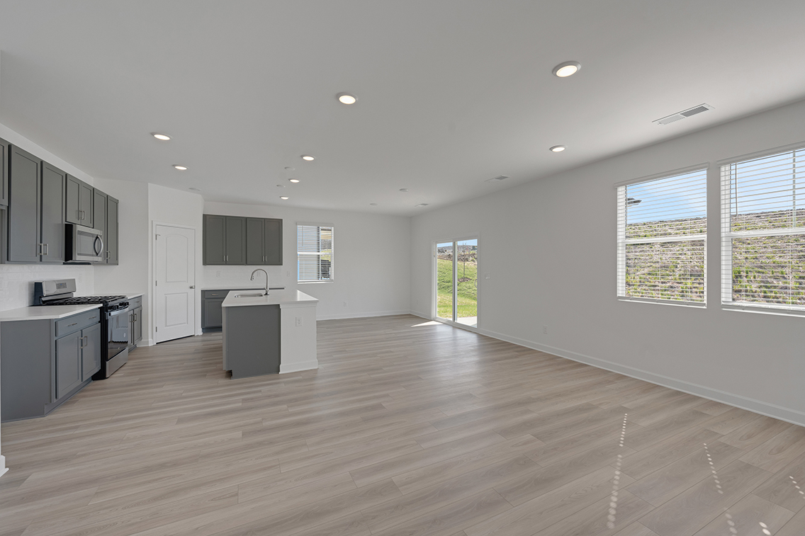 A large kitchen with black cabinets.