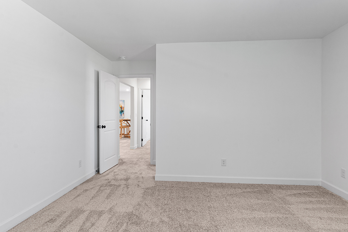 A hallway with white walls.