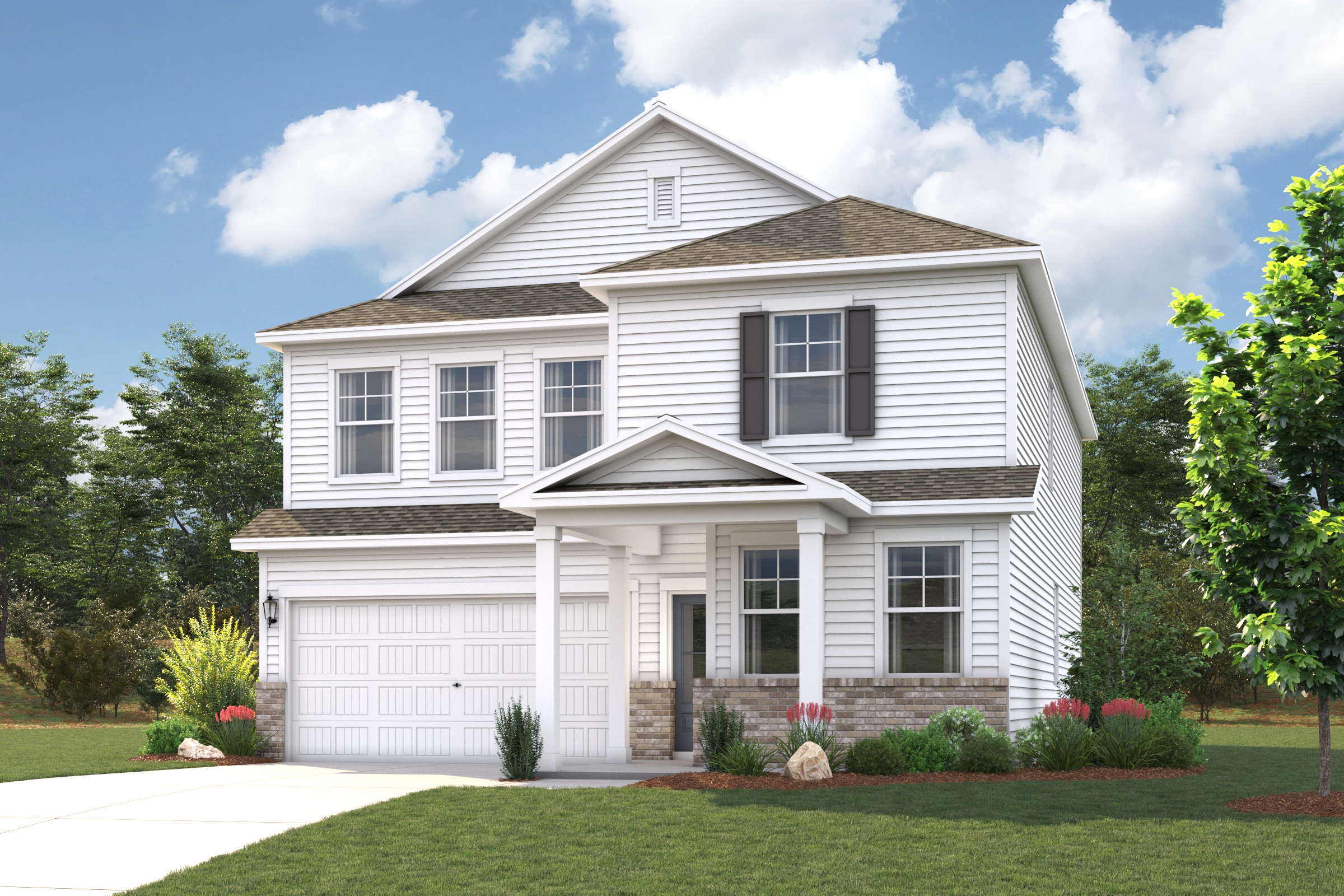 A white house with a lawn and trees in the front.