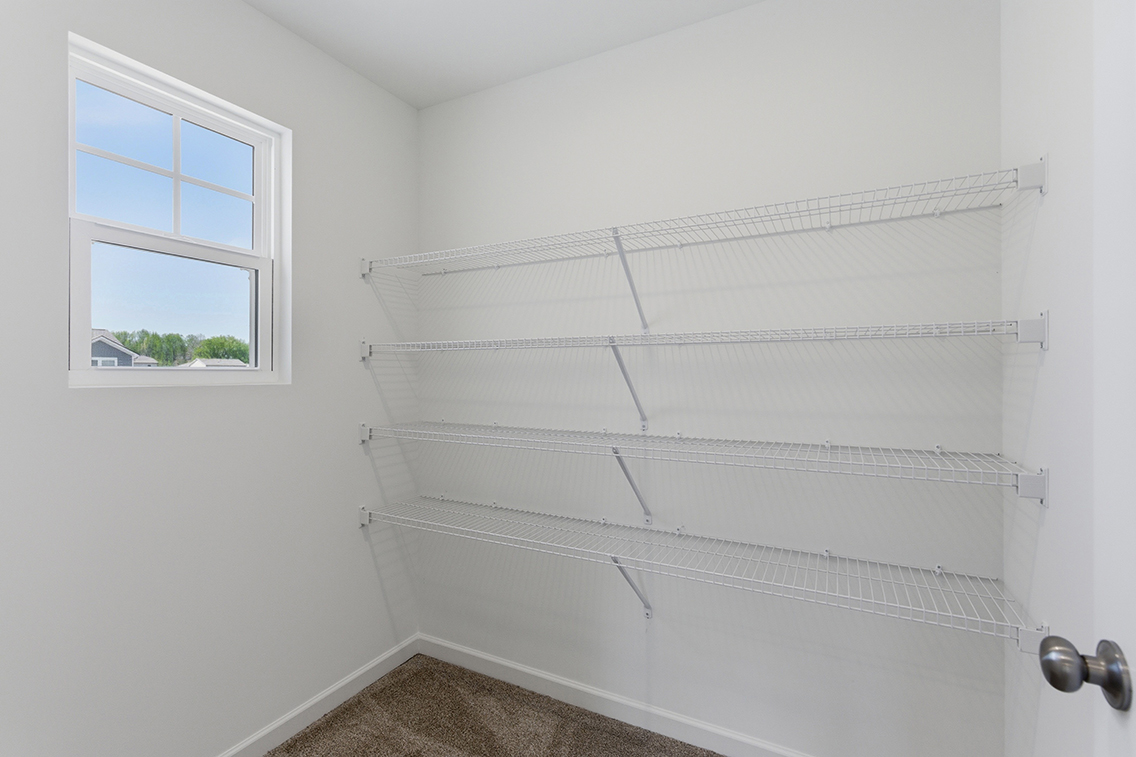 A white wall with a window.