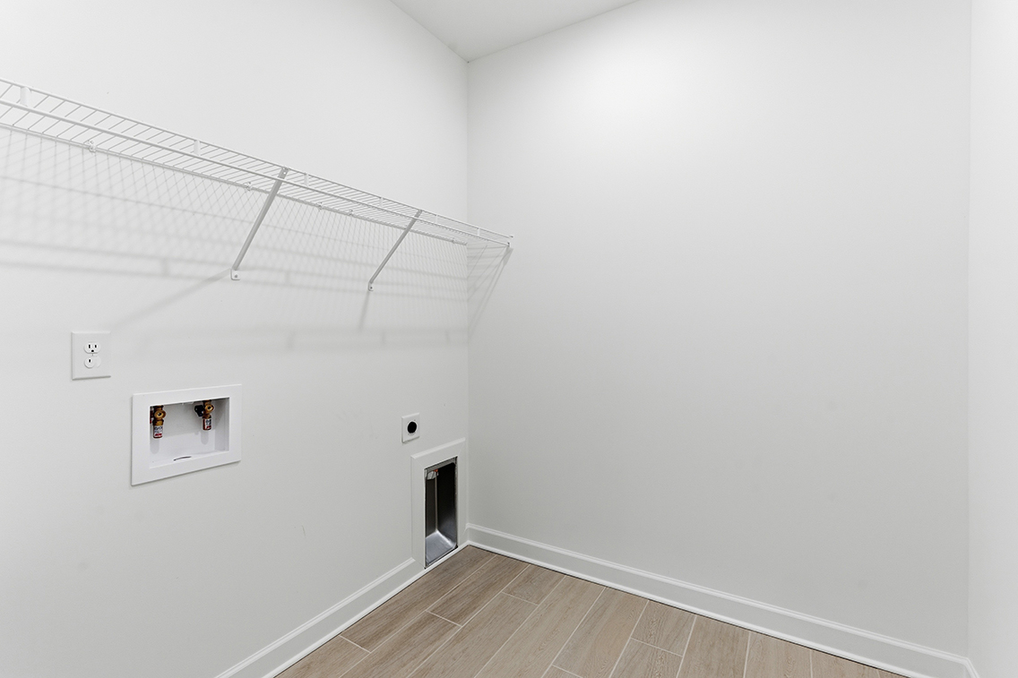 A white room with a wood floor.