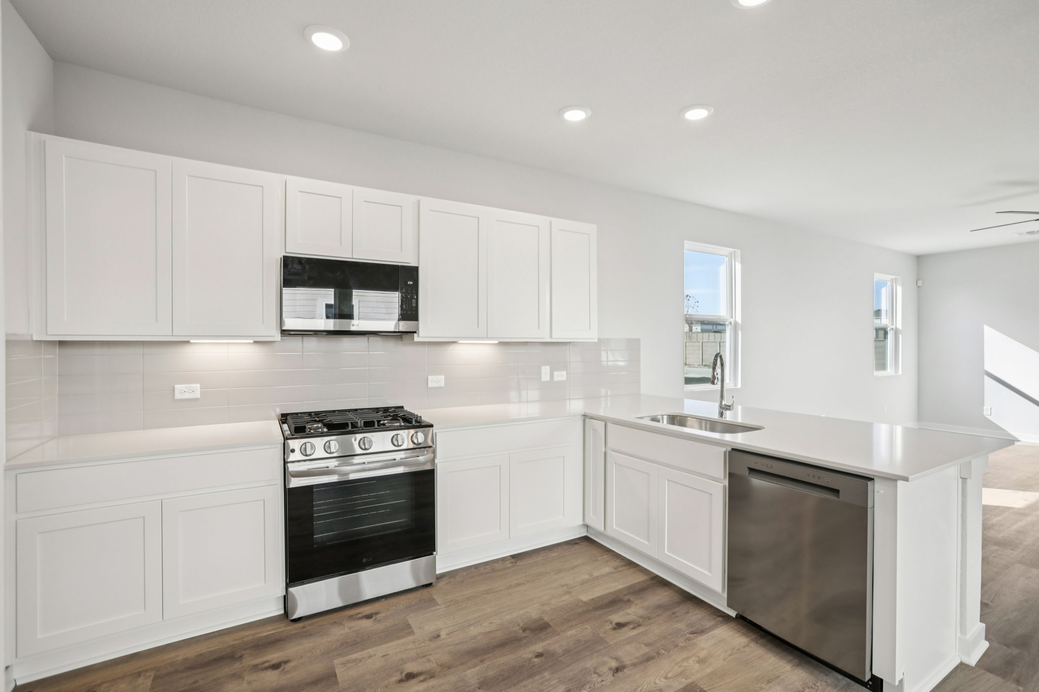 A kitchen with white cabinets.