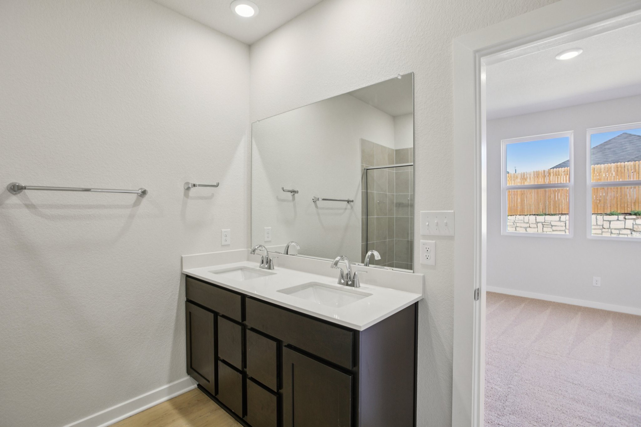 A bathroom with a large mirror.