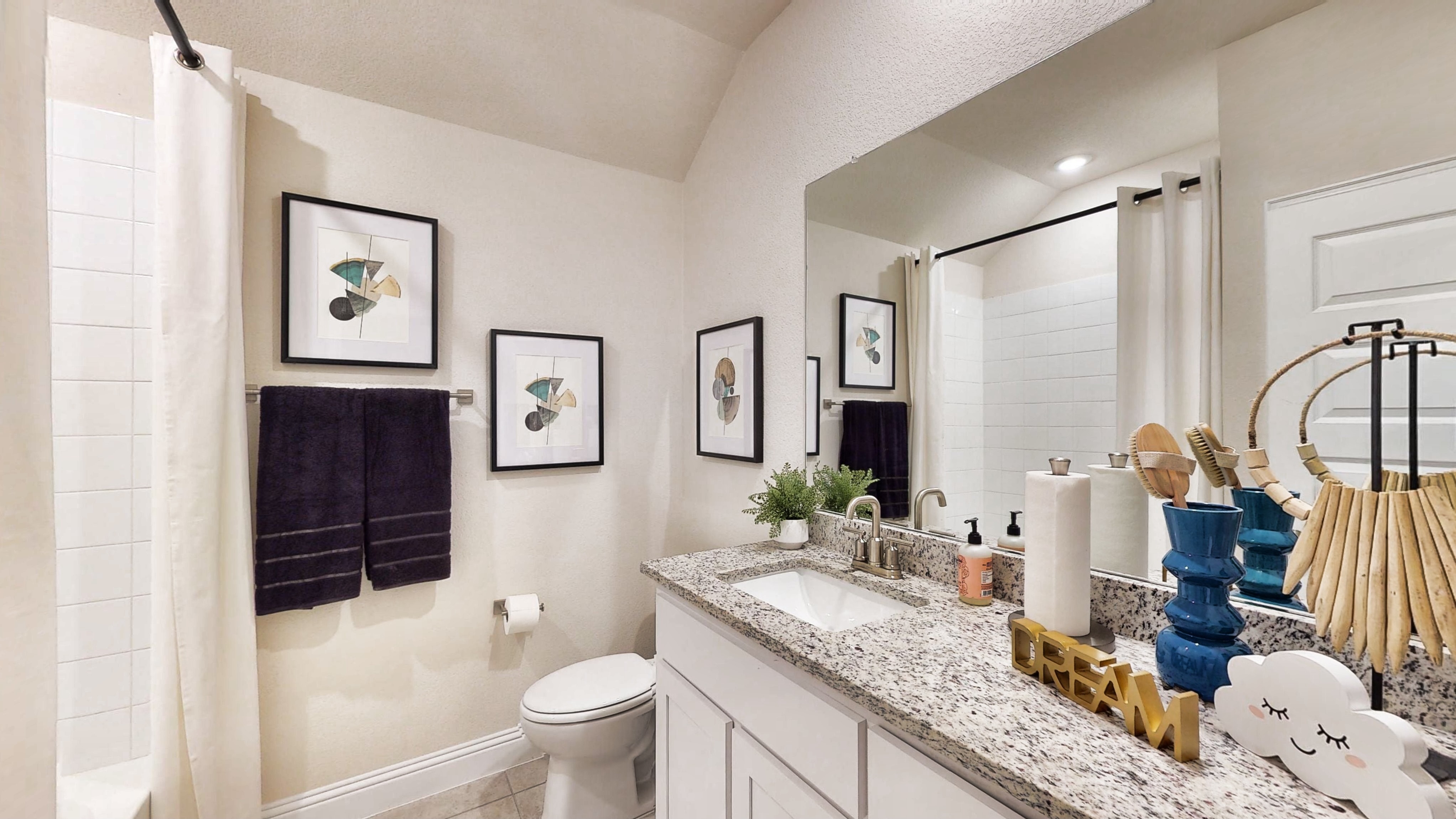 A bathroom with a large mirror.