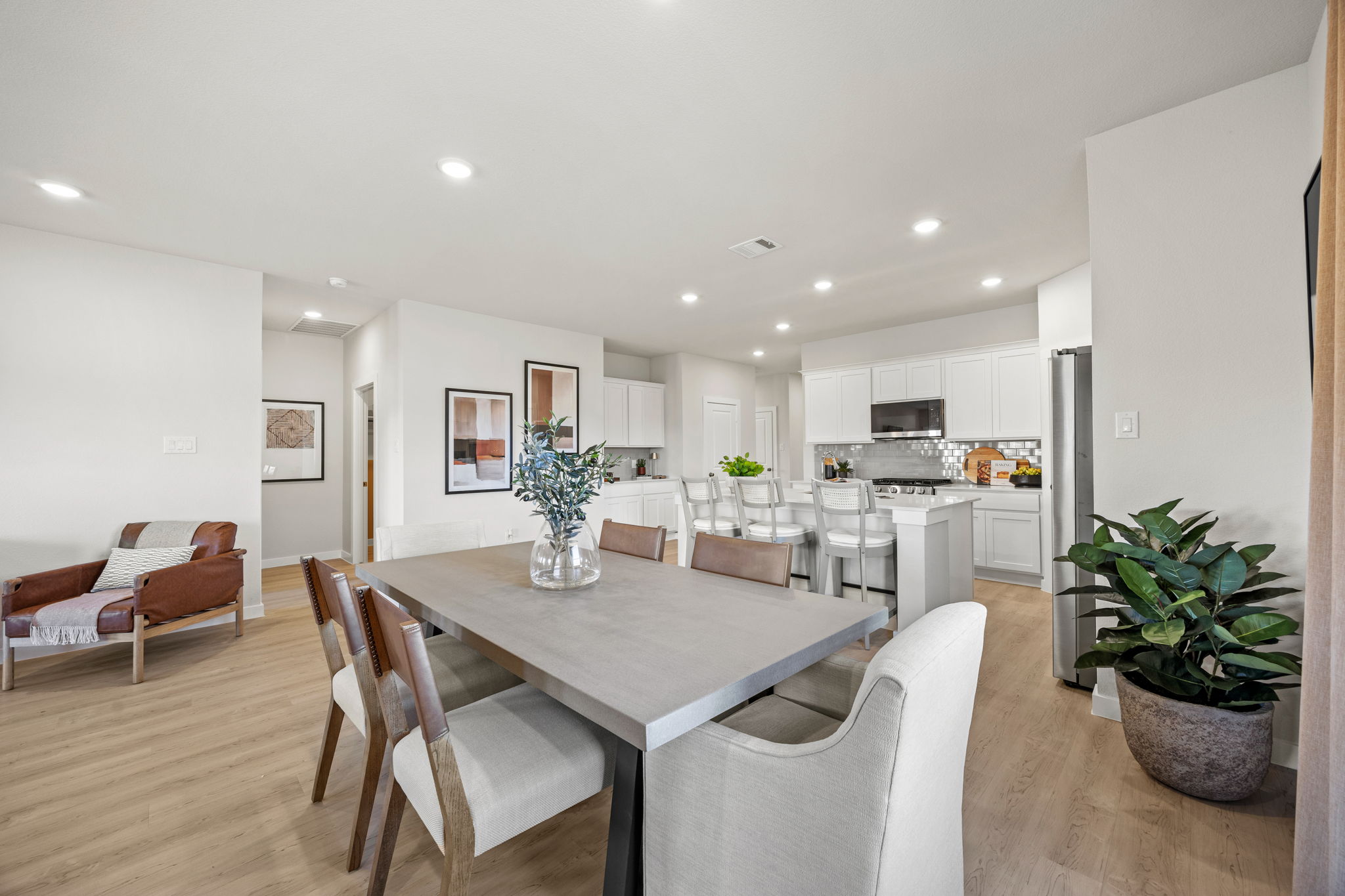 A large kitchen with a dining table.