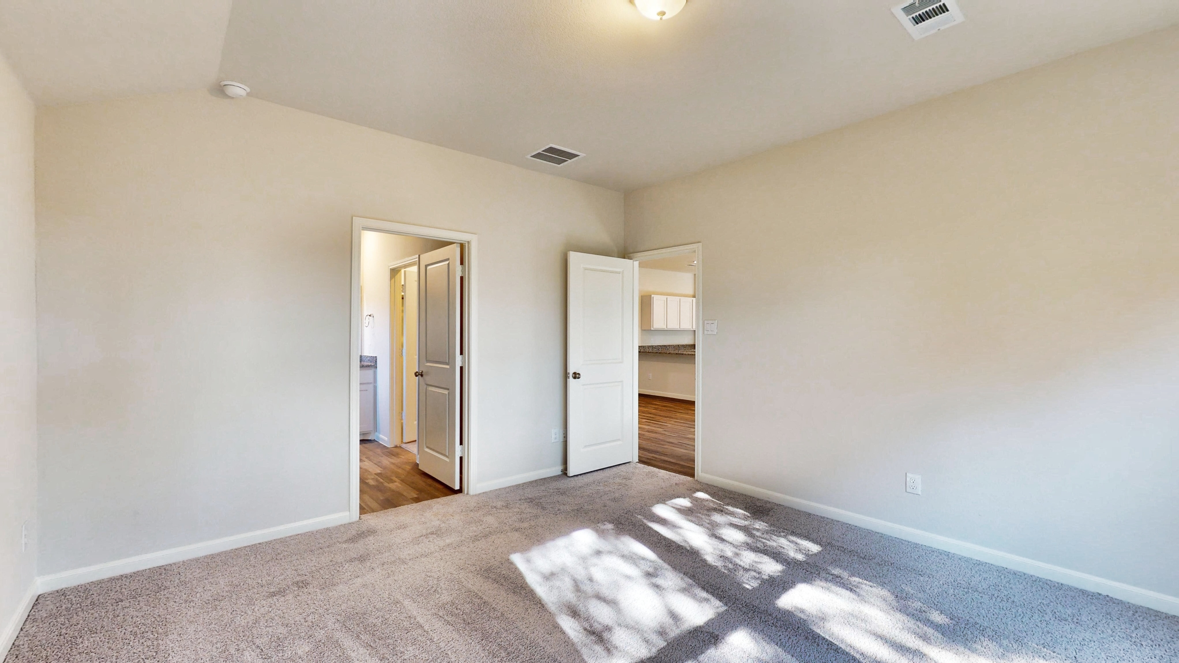 A room with a rug and a carpet.