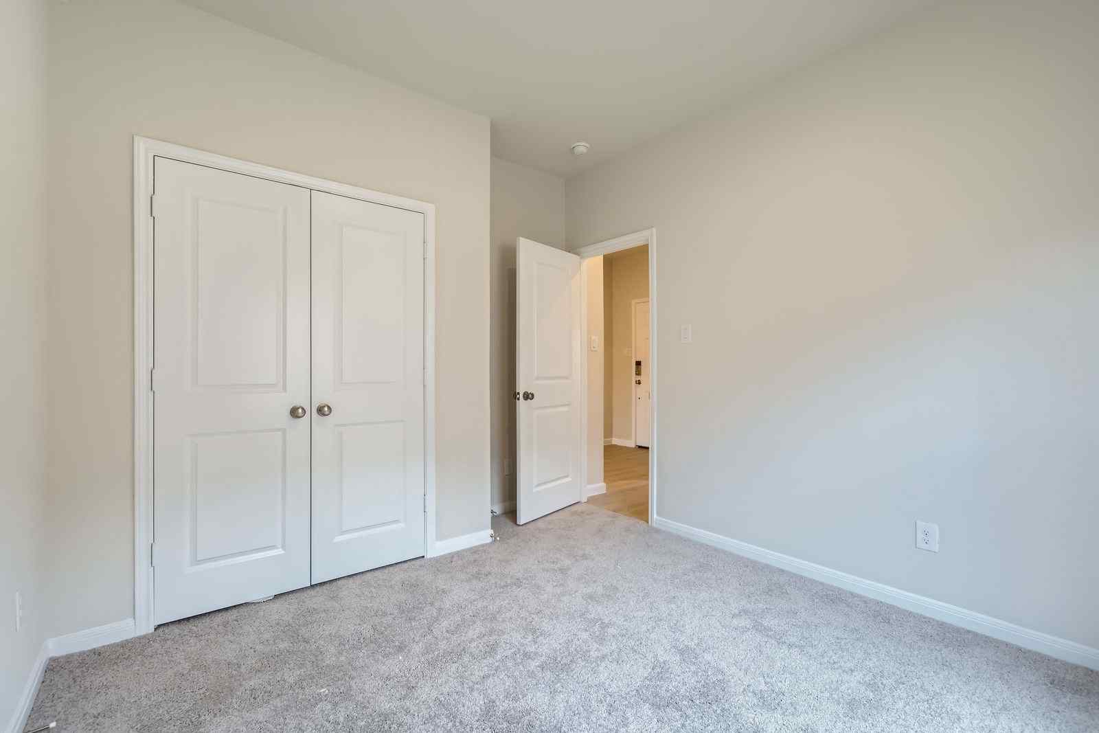 A hallway with white doors.