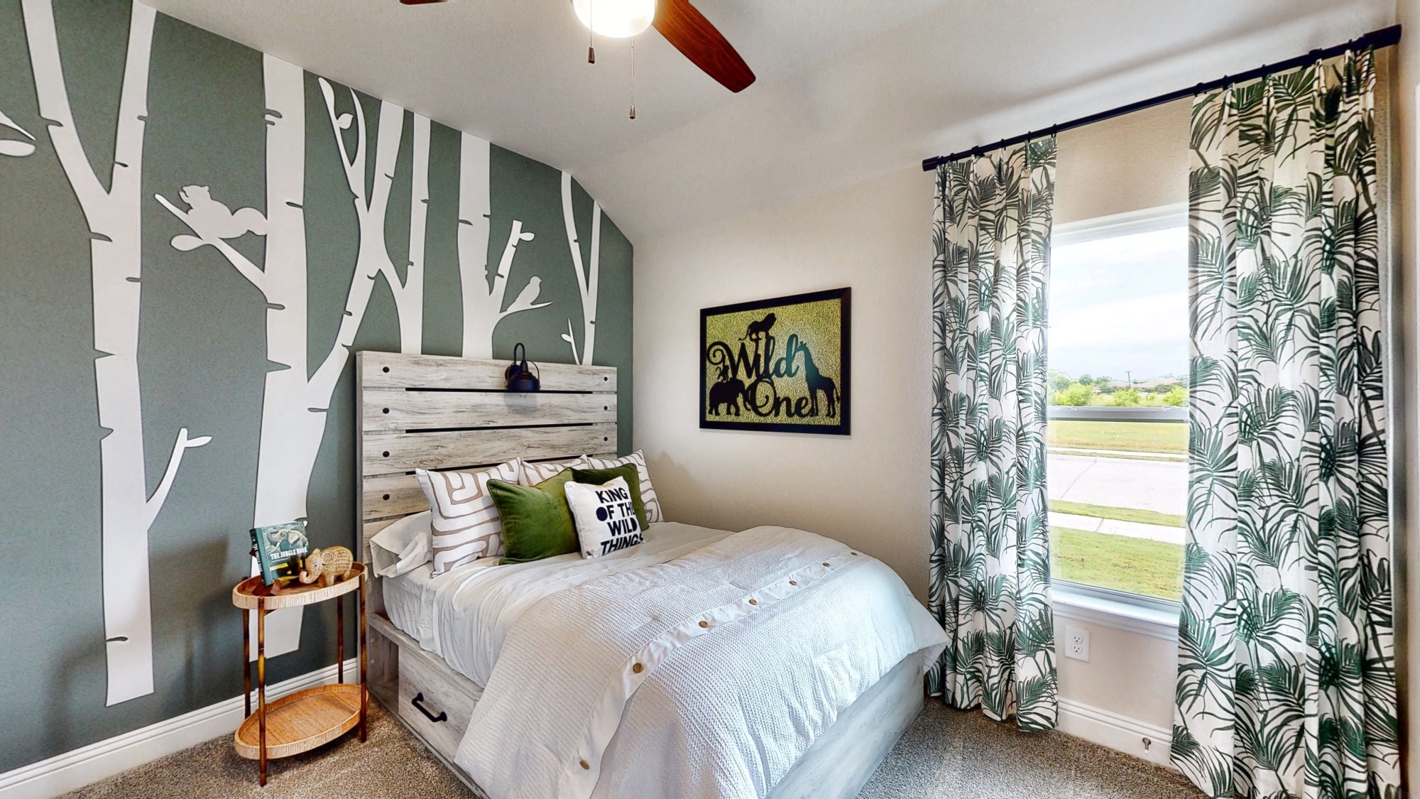 A bedroom with a large window.