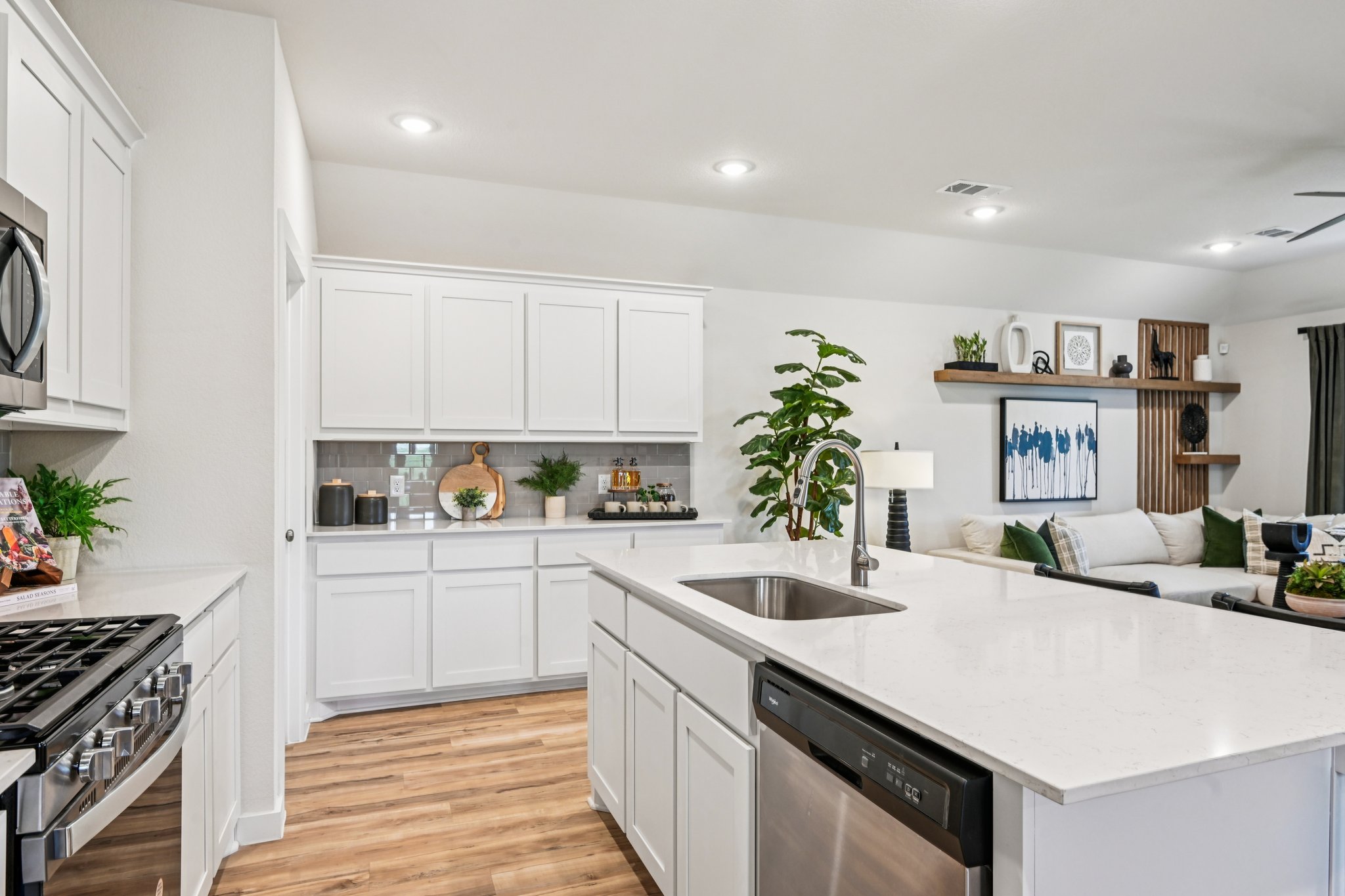 A kitchen with white cabinets.