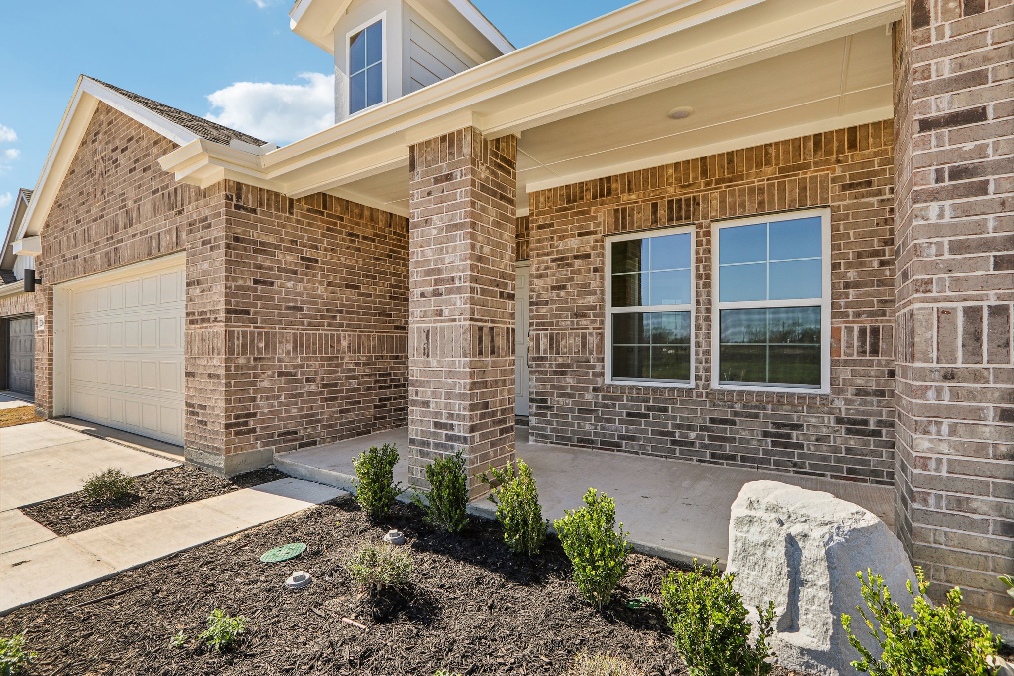 A brick building with a garage.