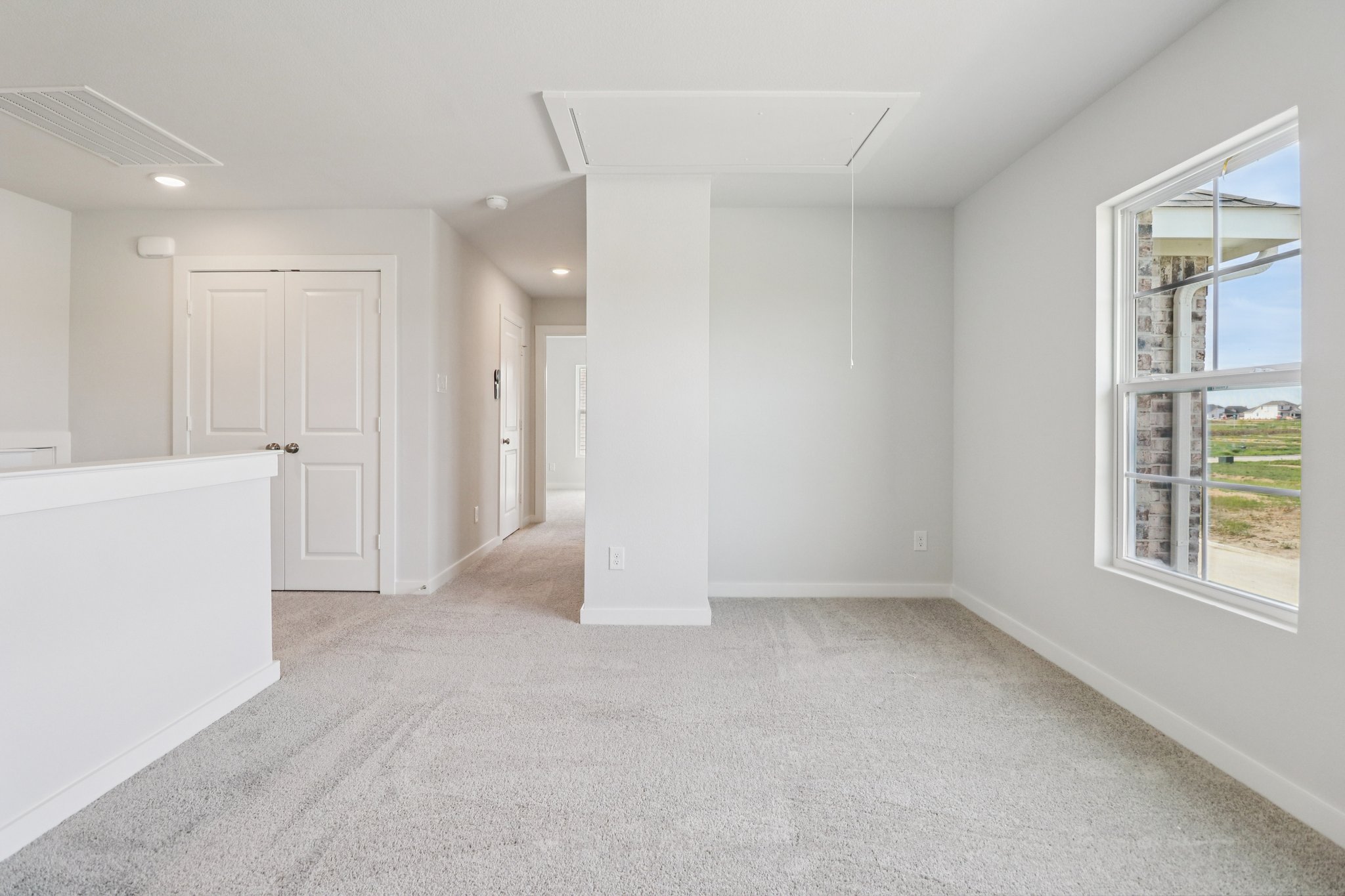 A room with white walls and windows.