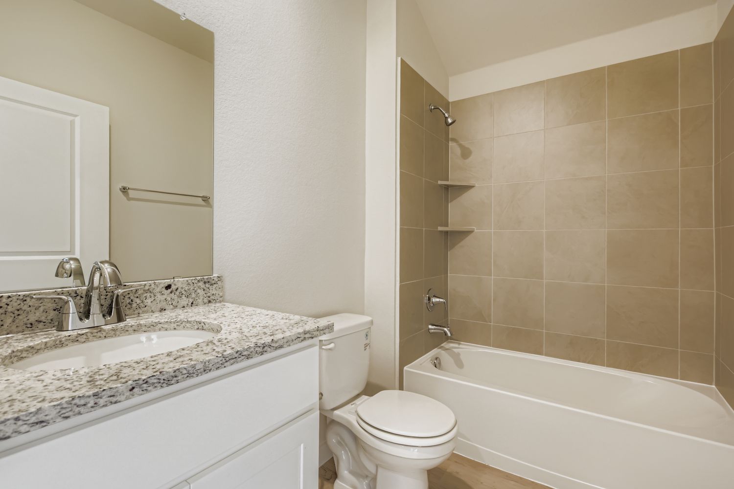 A bathroom with a tub sink and toilet.