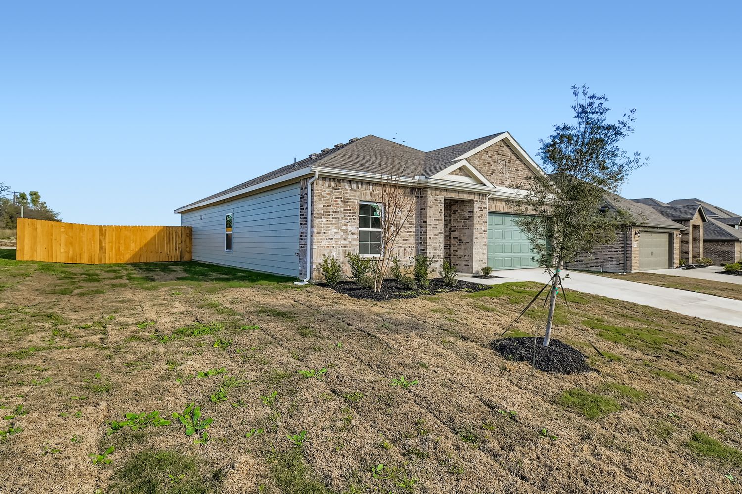 A house with a tree in the front.