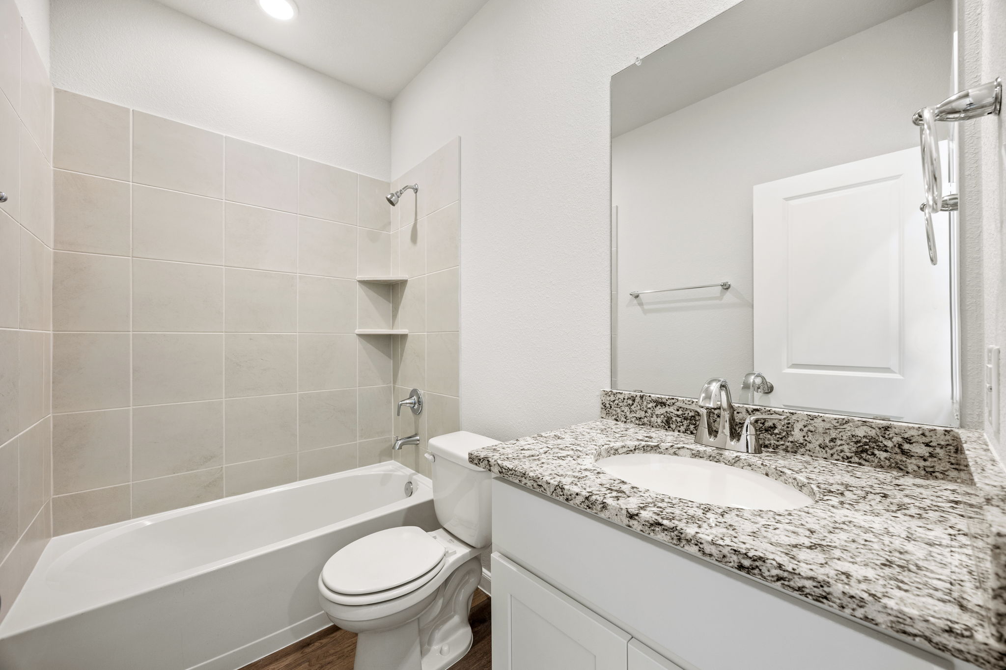 A bathroom with a marble countertop.
