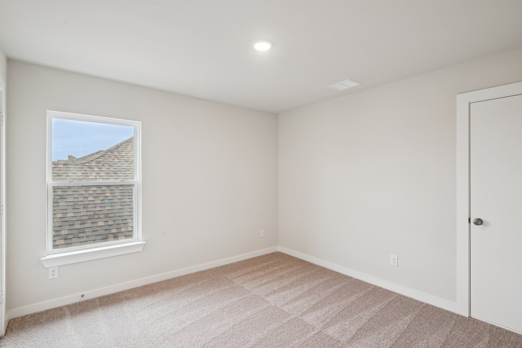 A room with a window and a door.