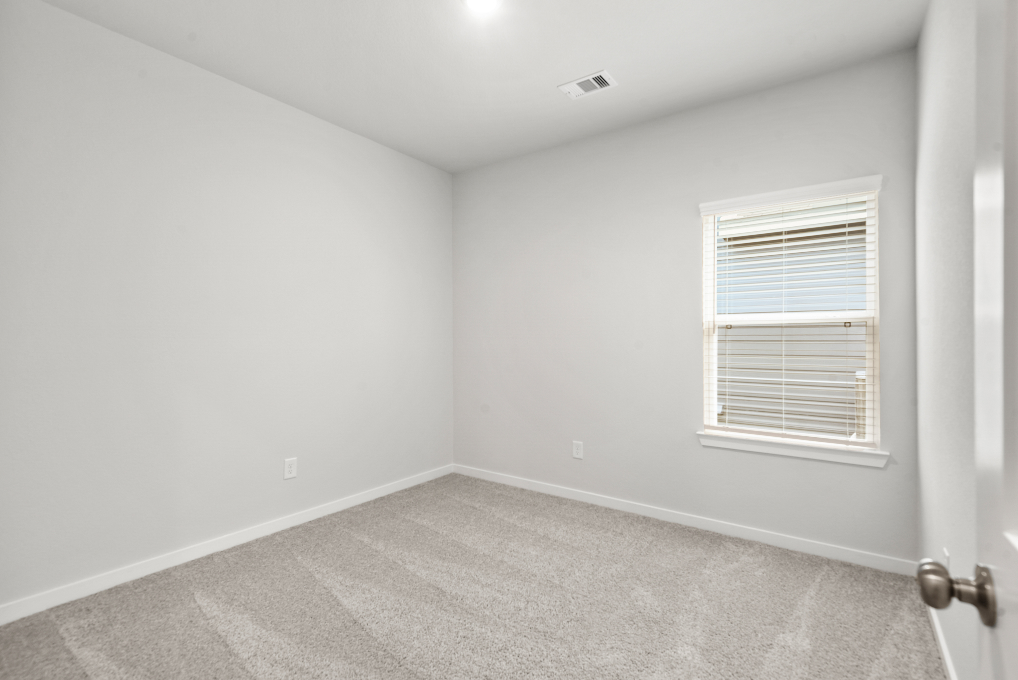 A room with a door and a window.