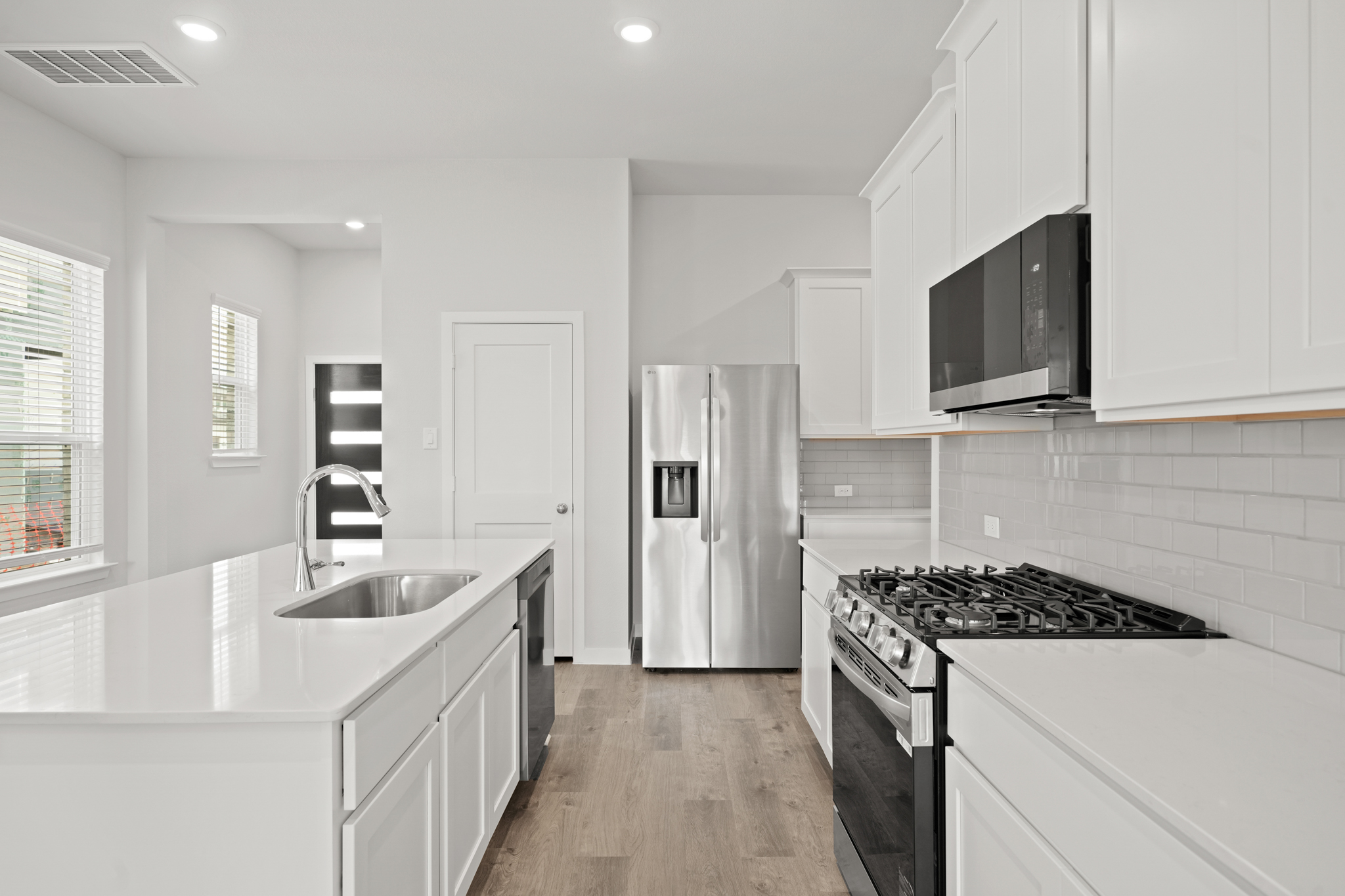 A kitchen with white cabinets.