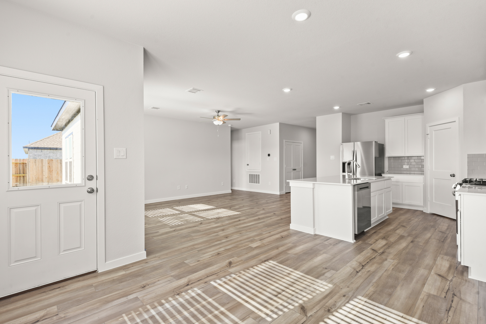A kitchen with white cabinets.