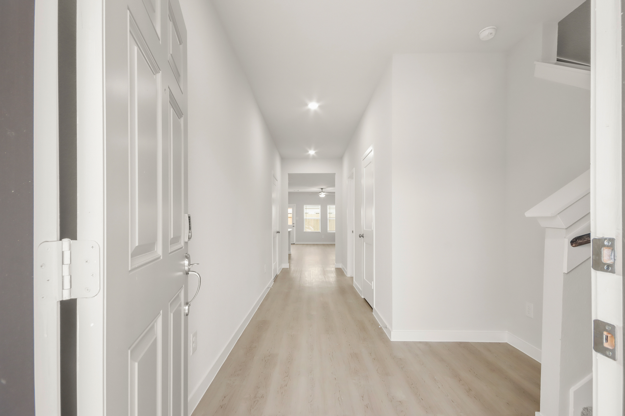 A hallway with white doors.