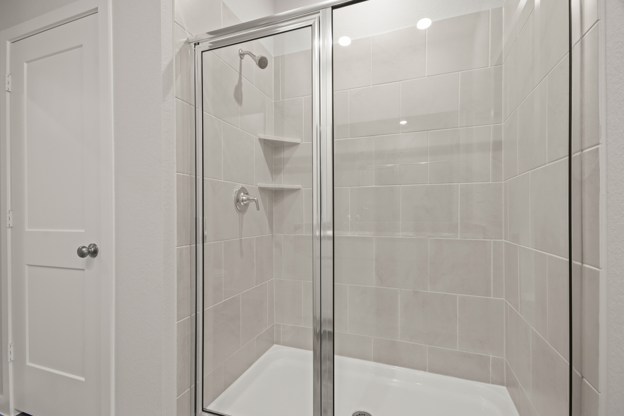 A shower with a glass door.