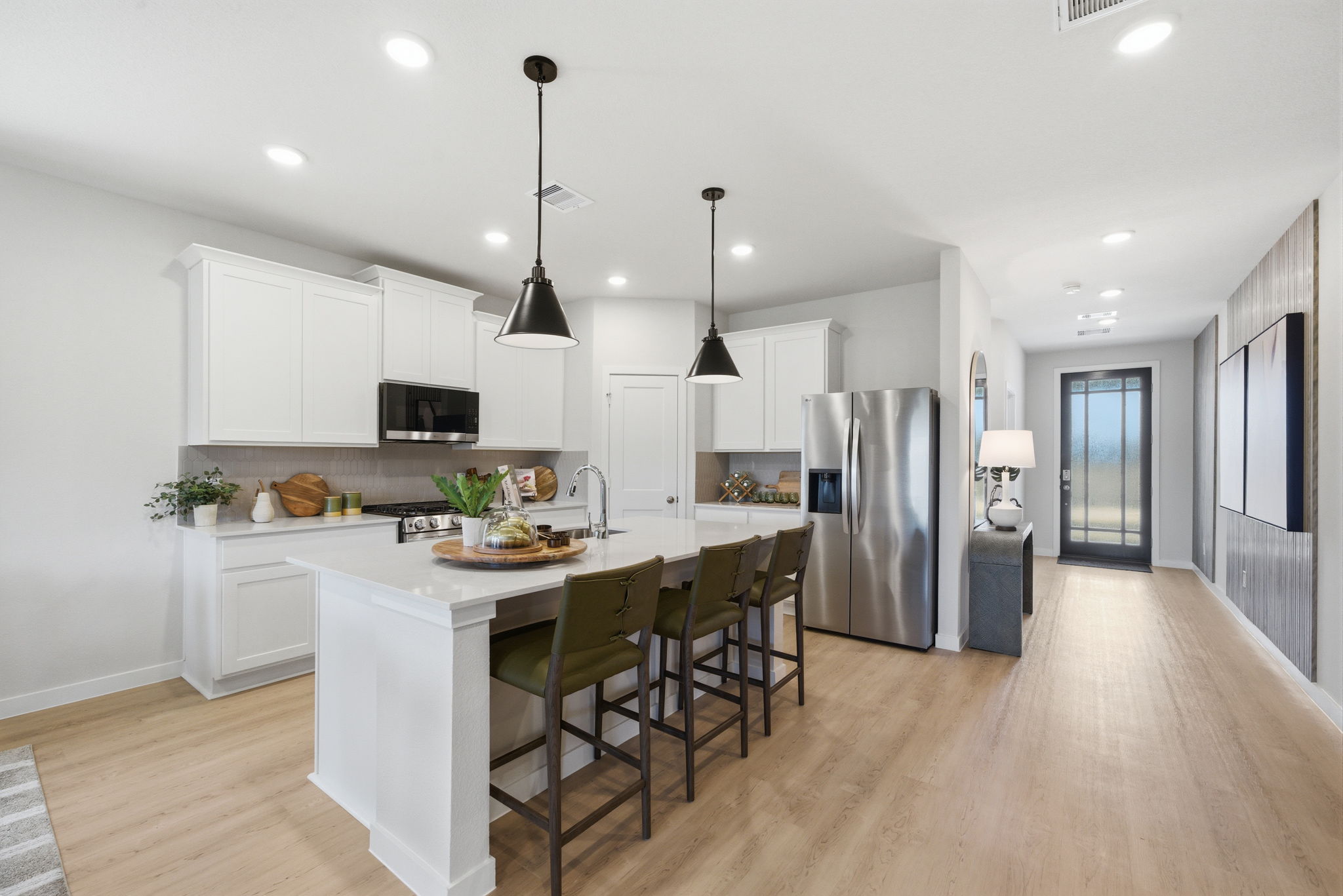 A kitchen with white cabinets.