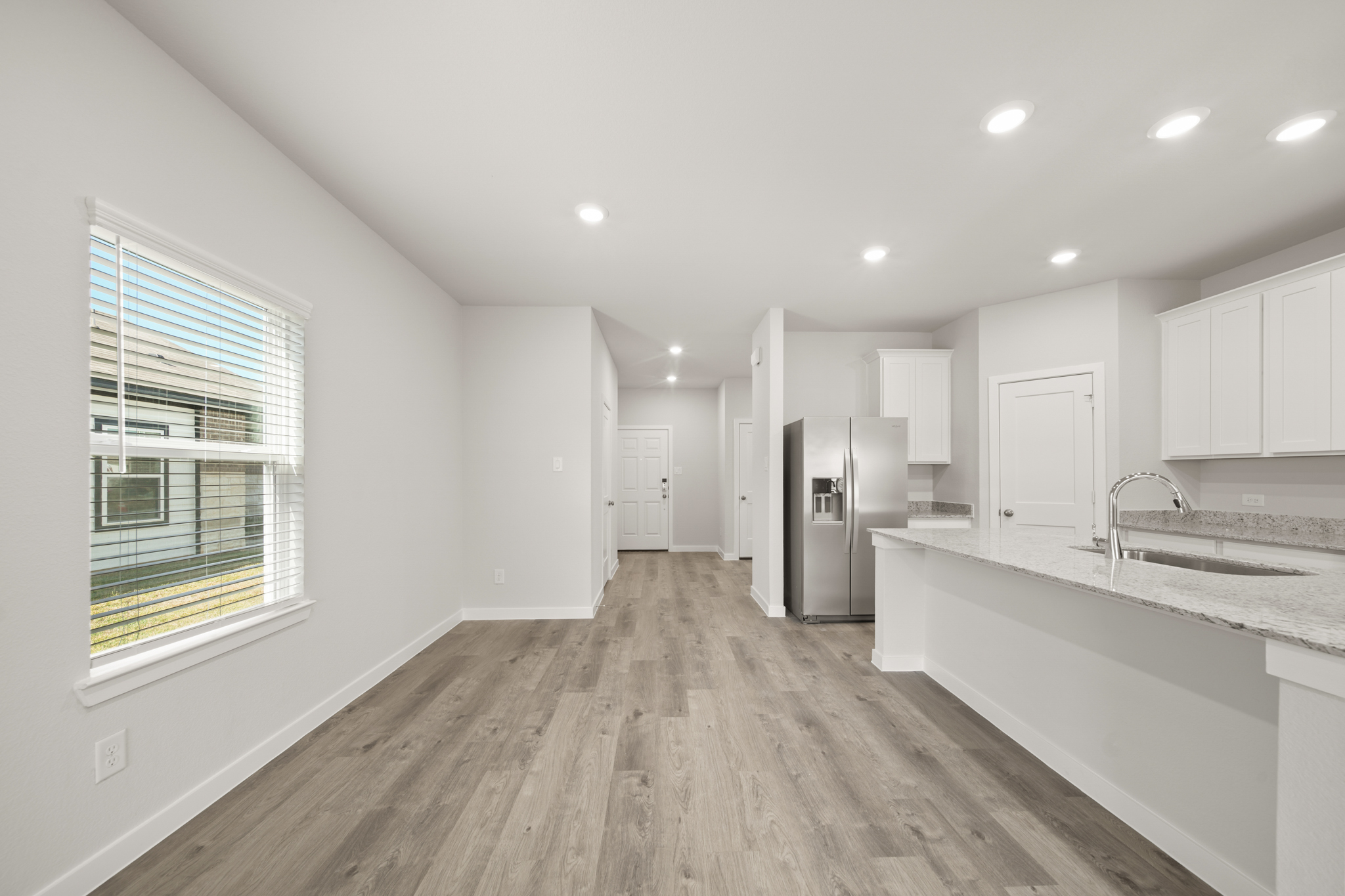 A kitchen with white cabinets.