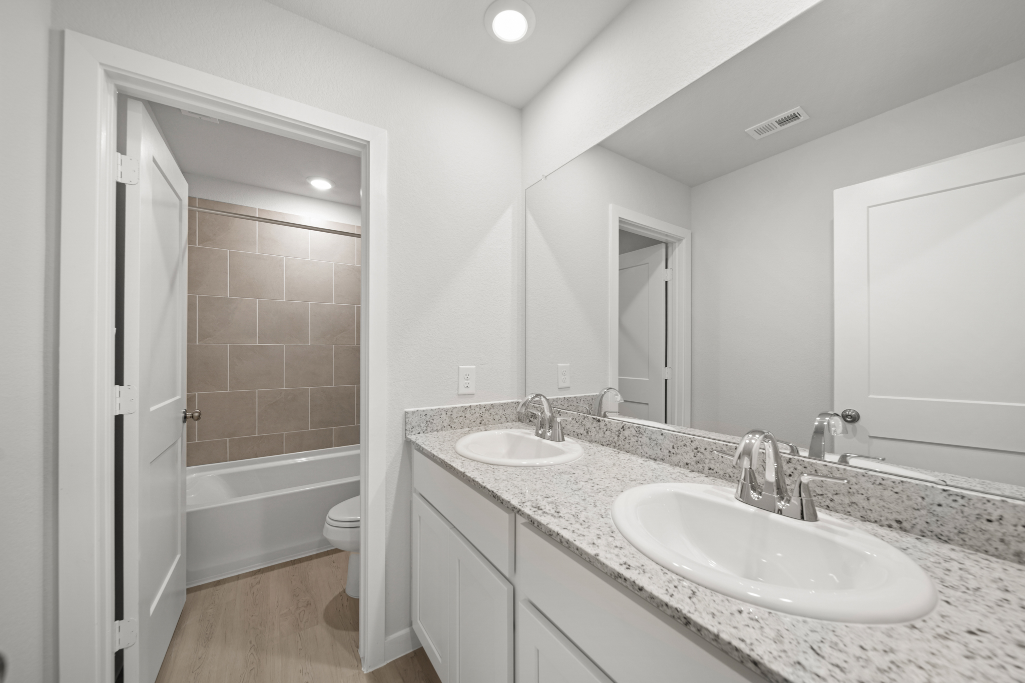A bathroom with a tub sink and a toilet.