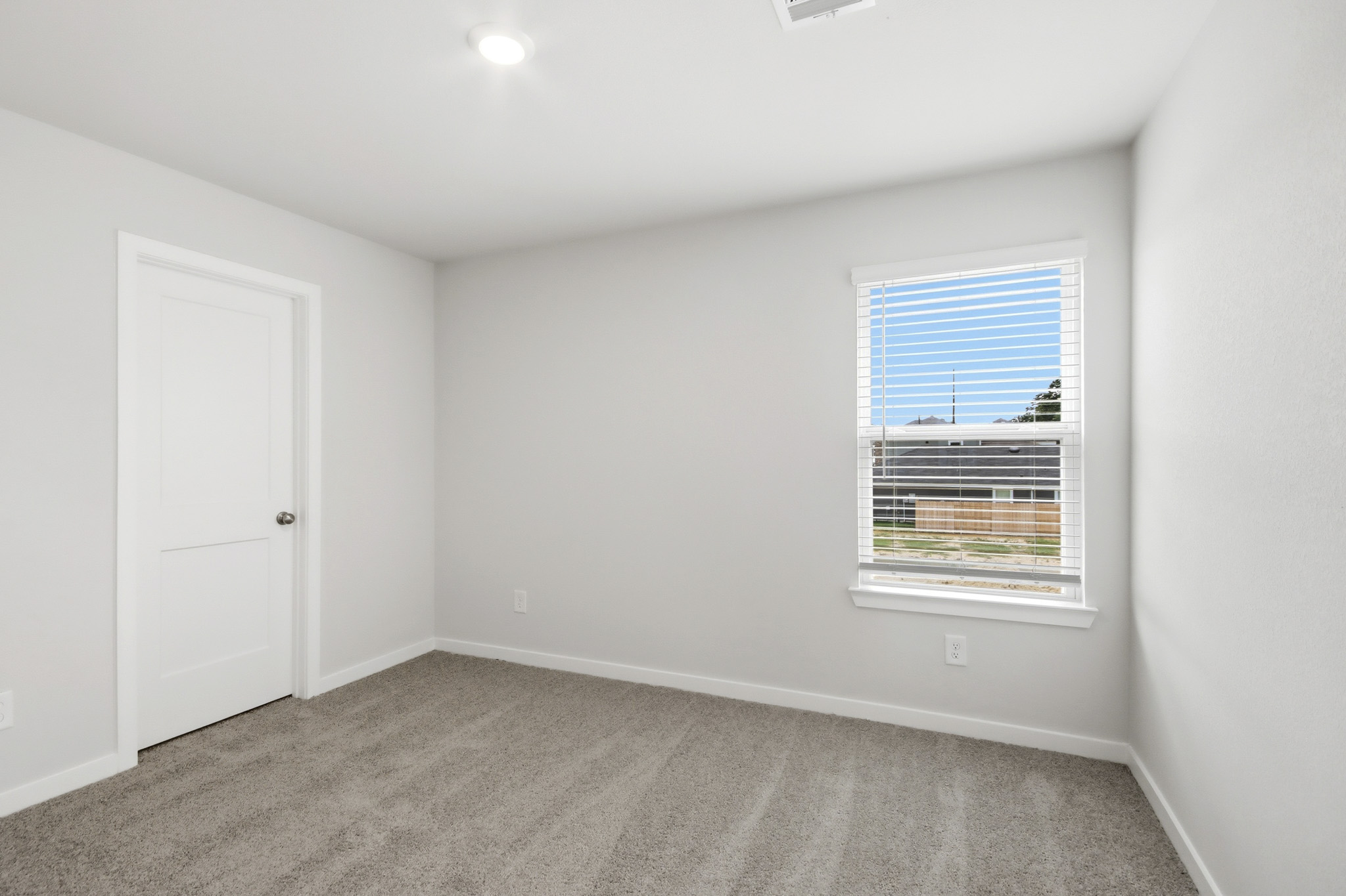 A room with a window and a door.