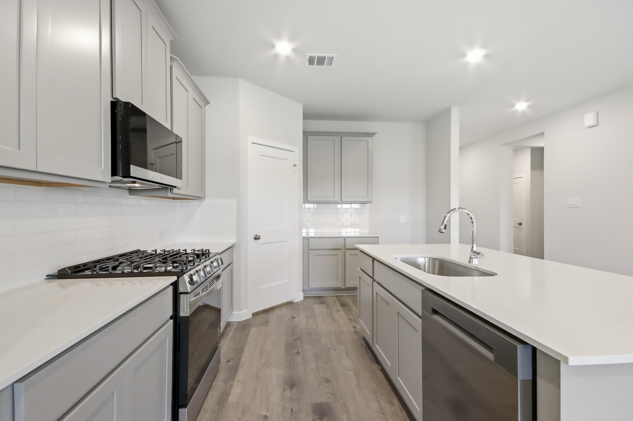 A kitchen with white cabinets.