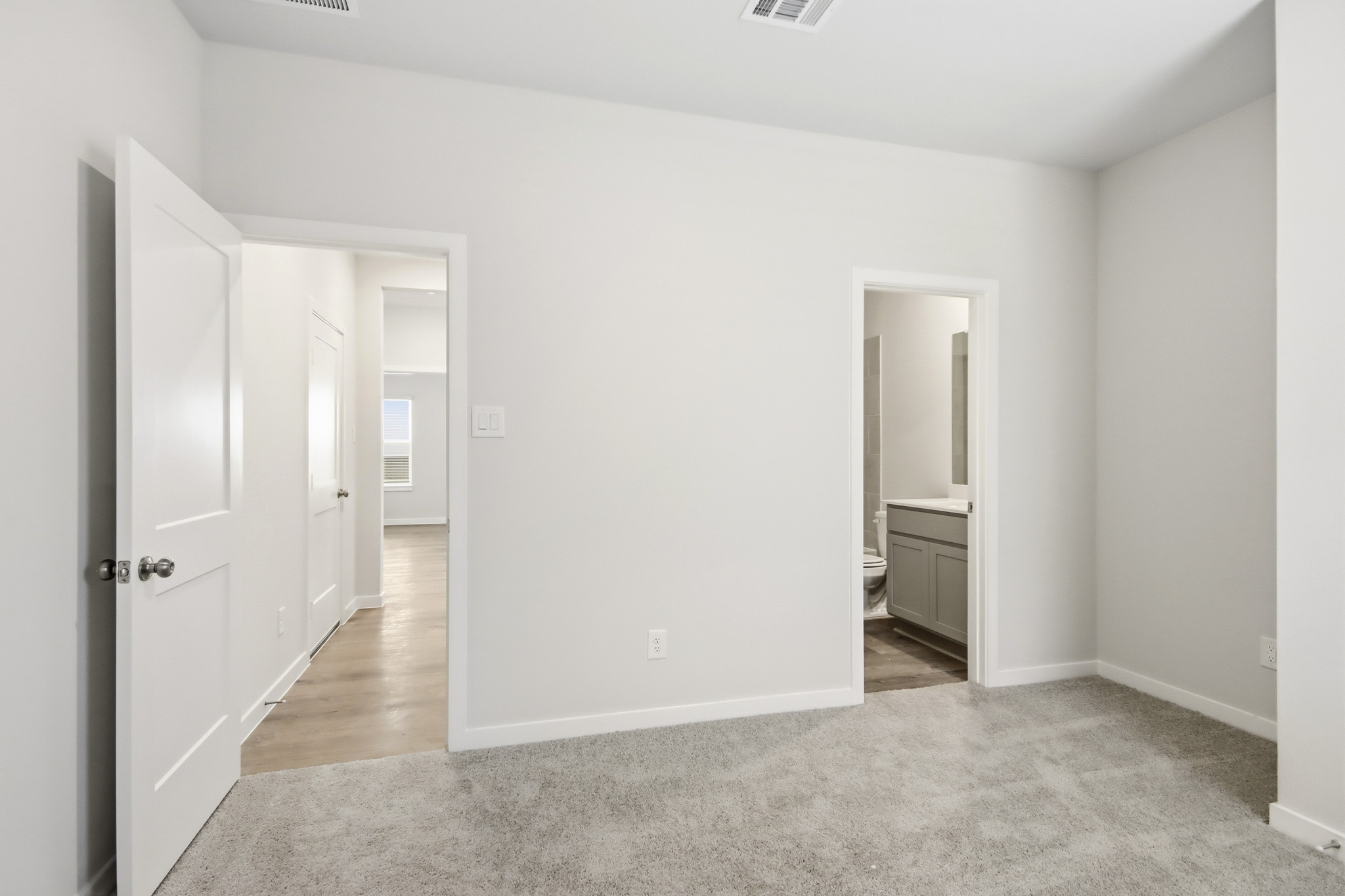 A hallway with white doors.