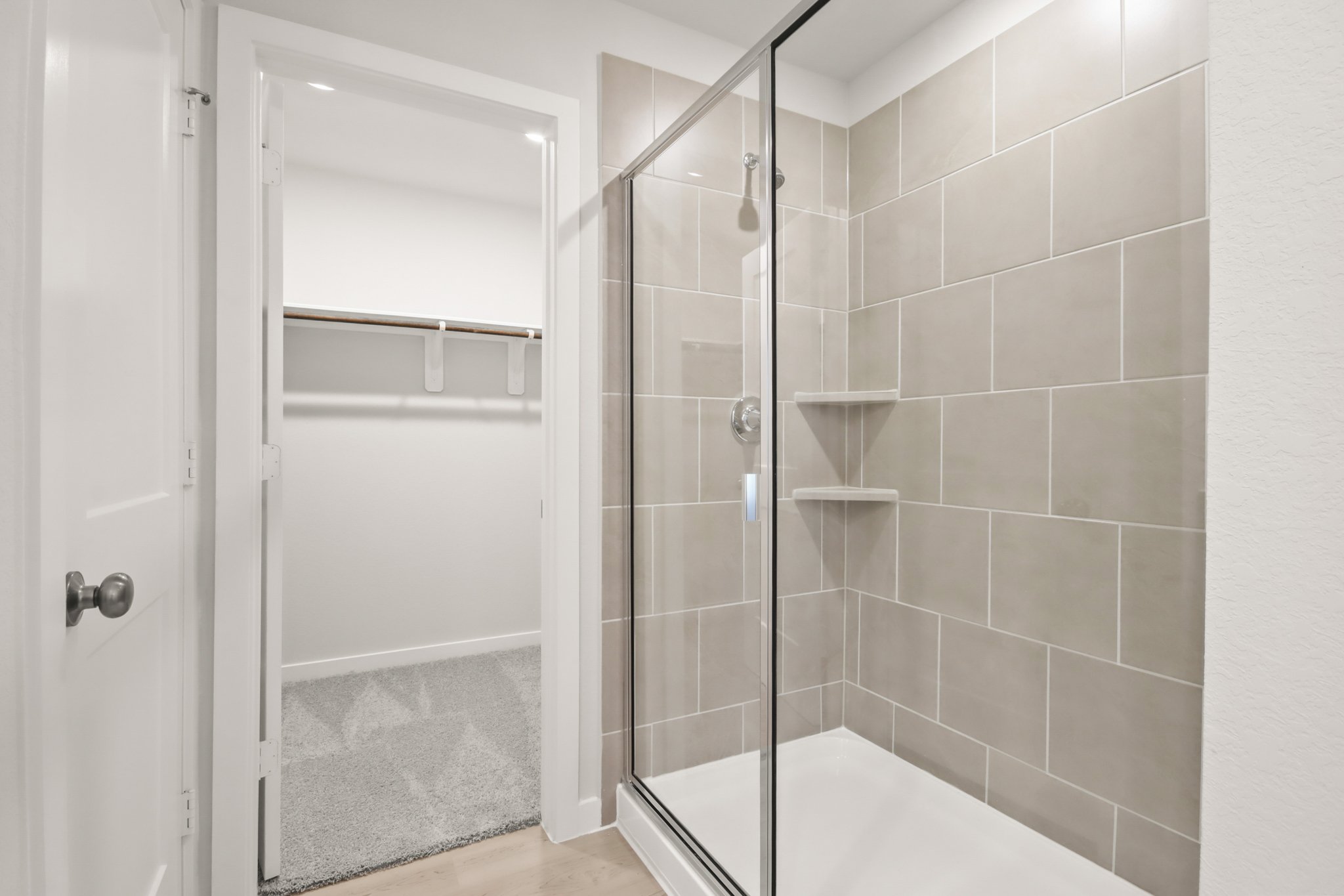 A shower with a glass door.