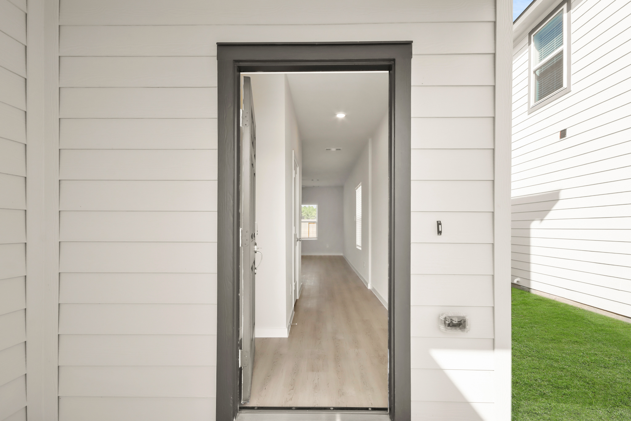 A hallway with a glass door.