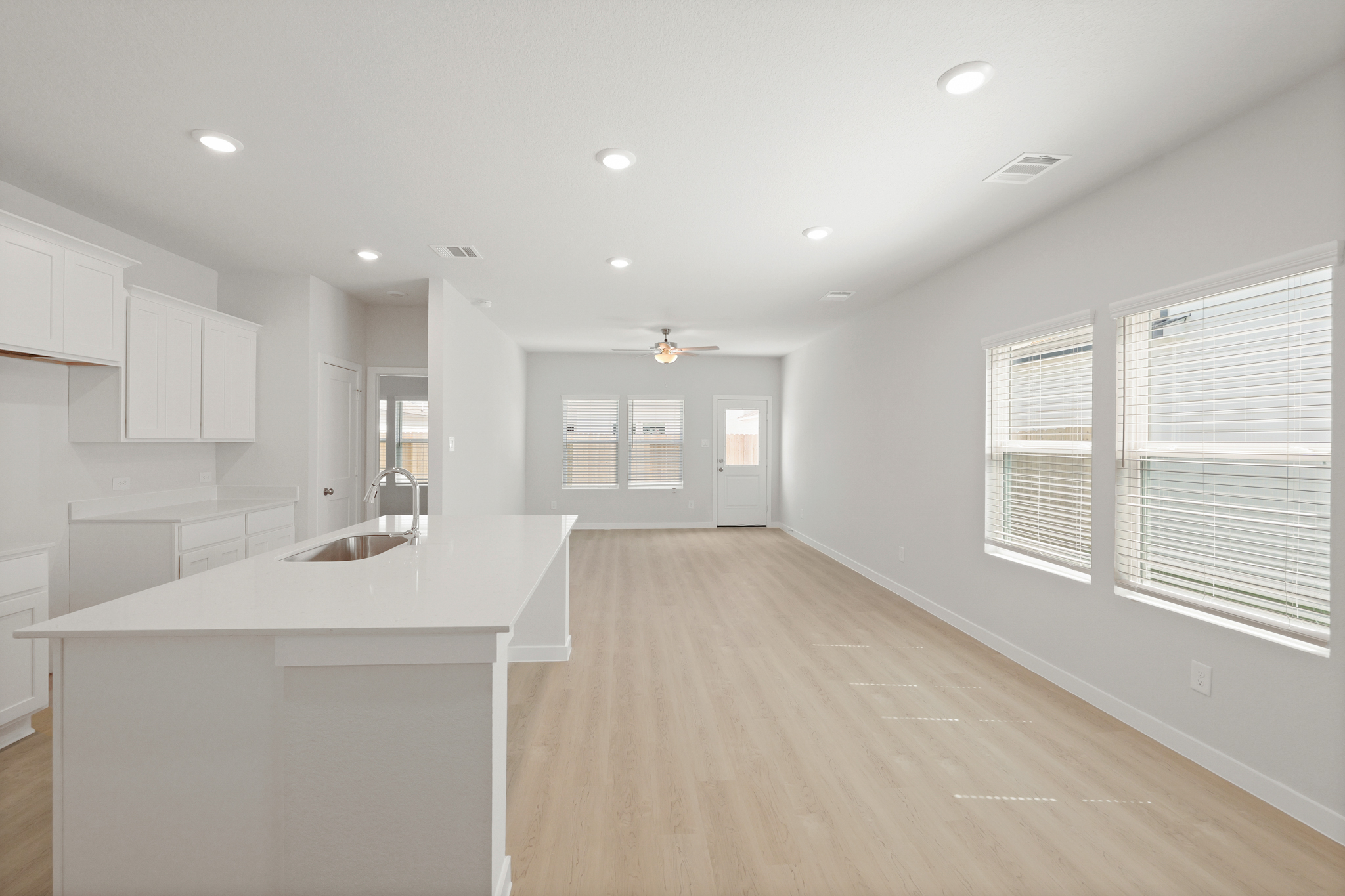 A kitchen with white cabinets.