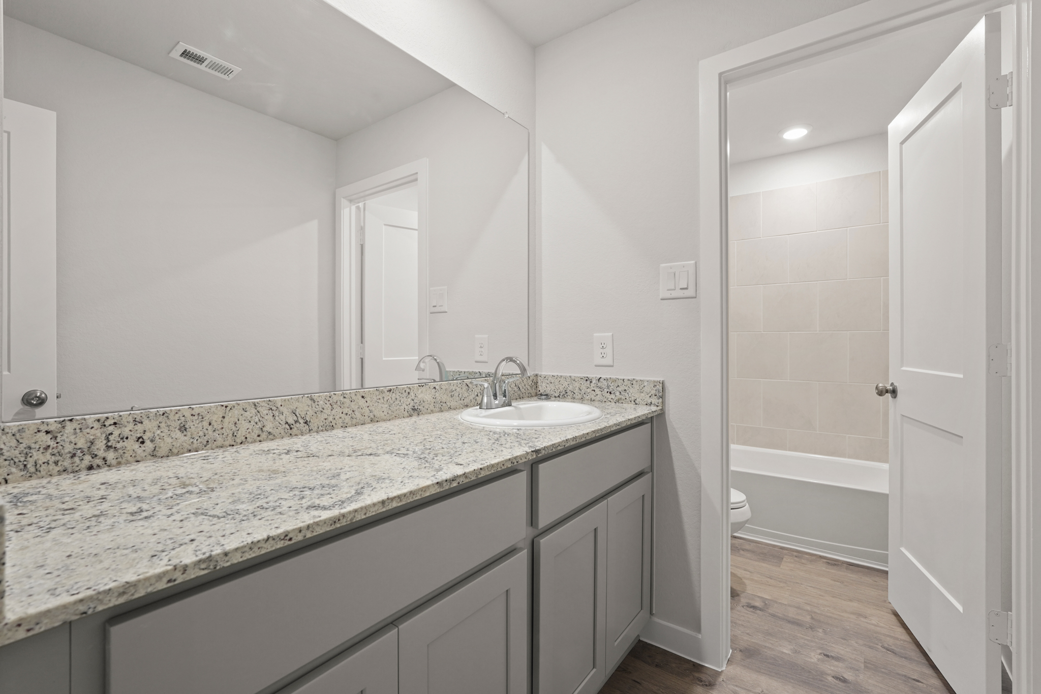 A bathroom with marble countertop.