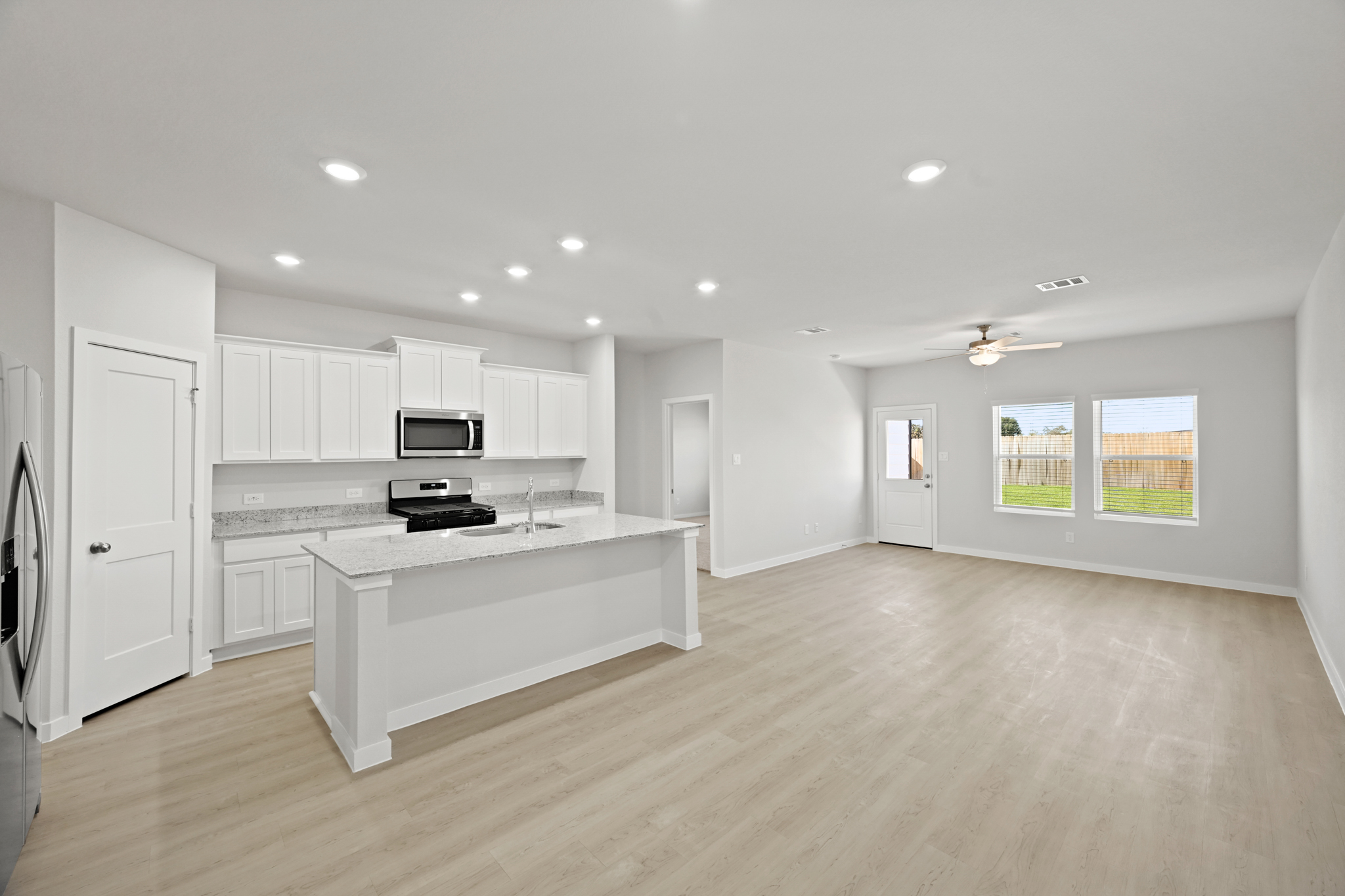 A large kitchen with white cabinets.