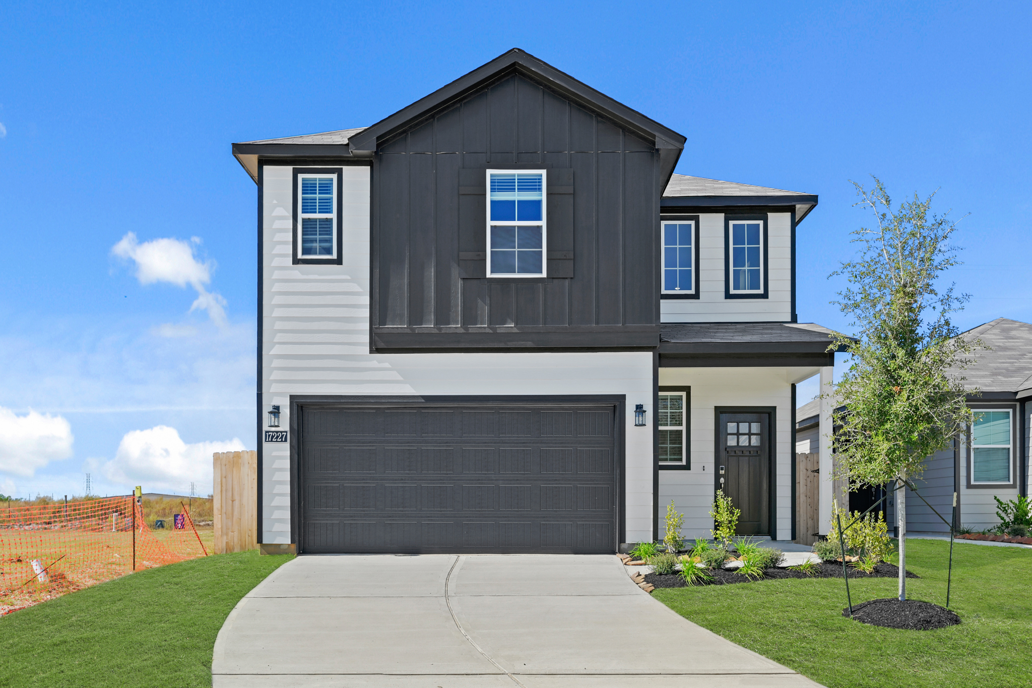 A grey house with a garage.