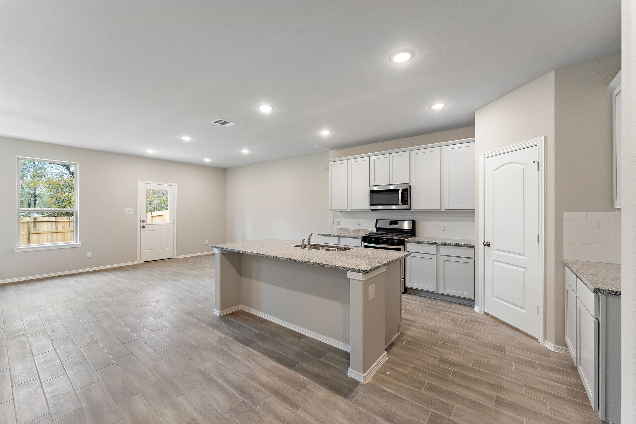 A kitchen with white cabinets.