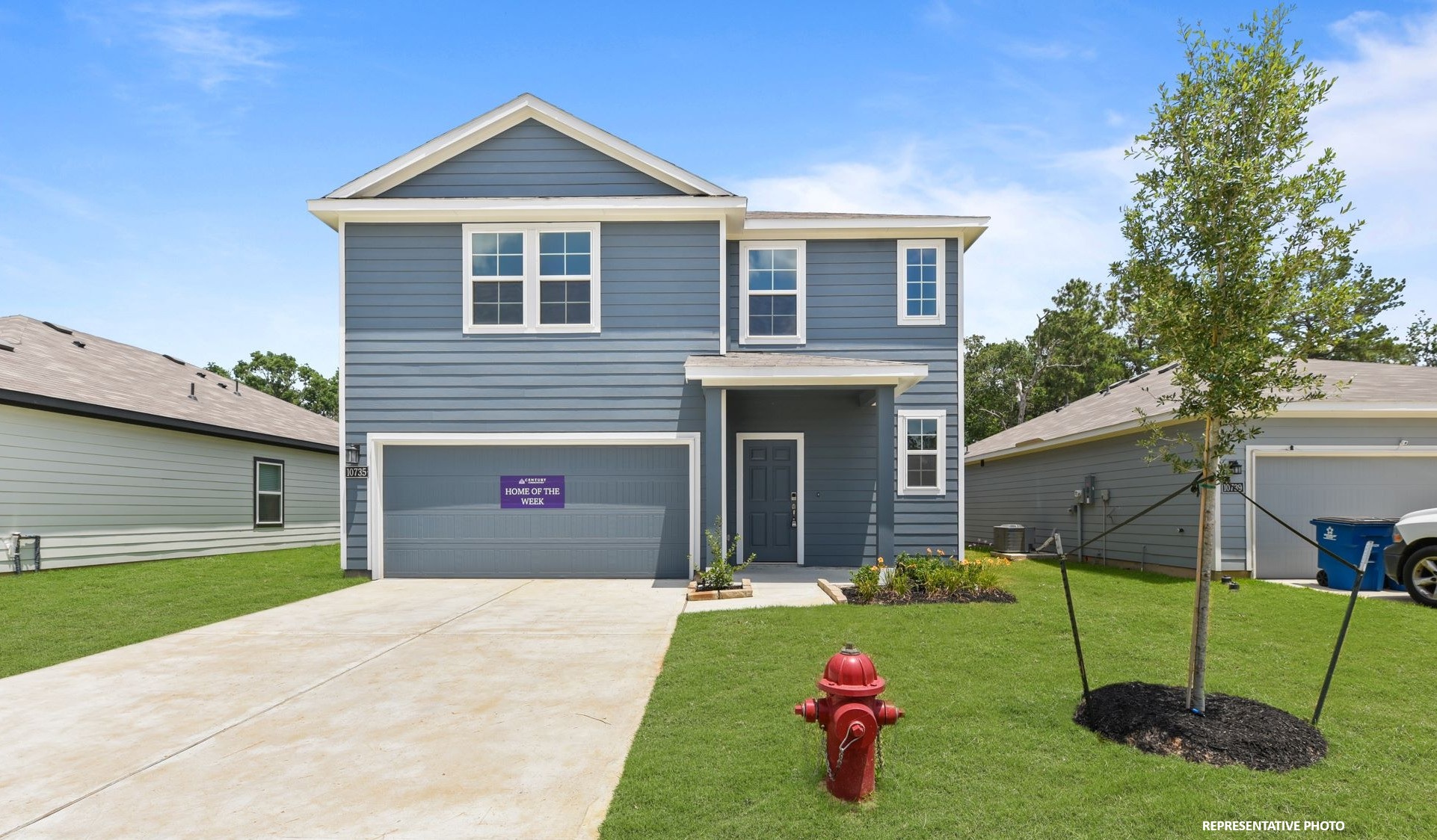 A house with a red fire hydrant in front of it.