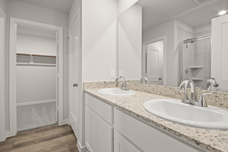 A bathroom with a large mirror.