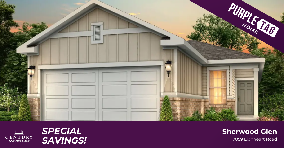 A house with garages and a sign on the side.