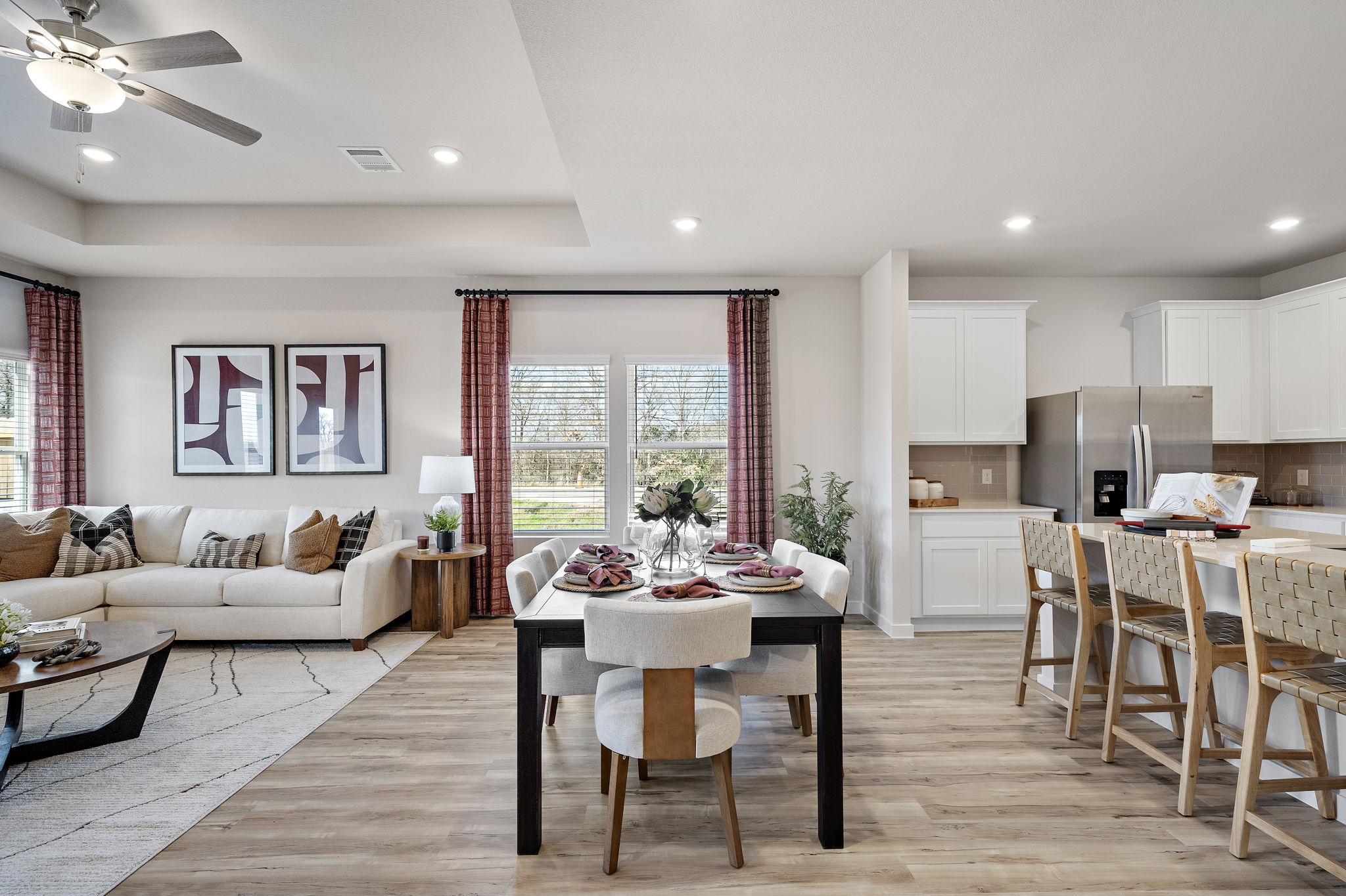 A large living room with a large table and chairs.